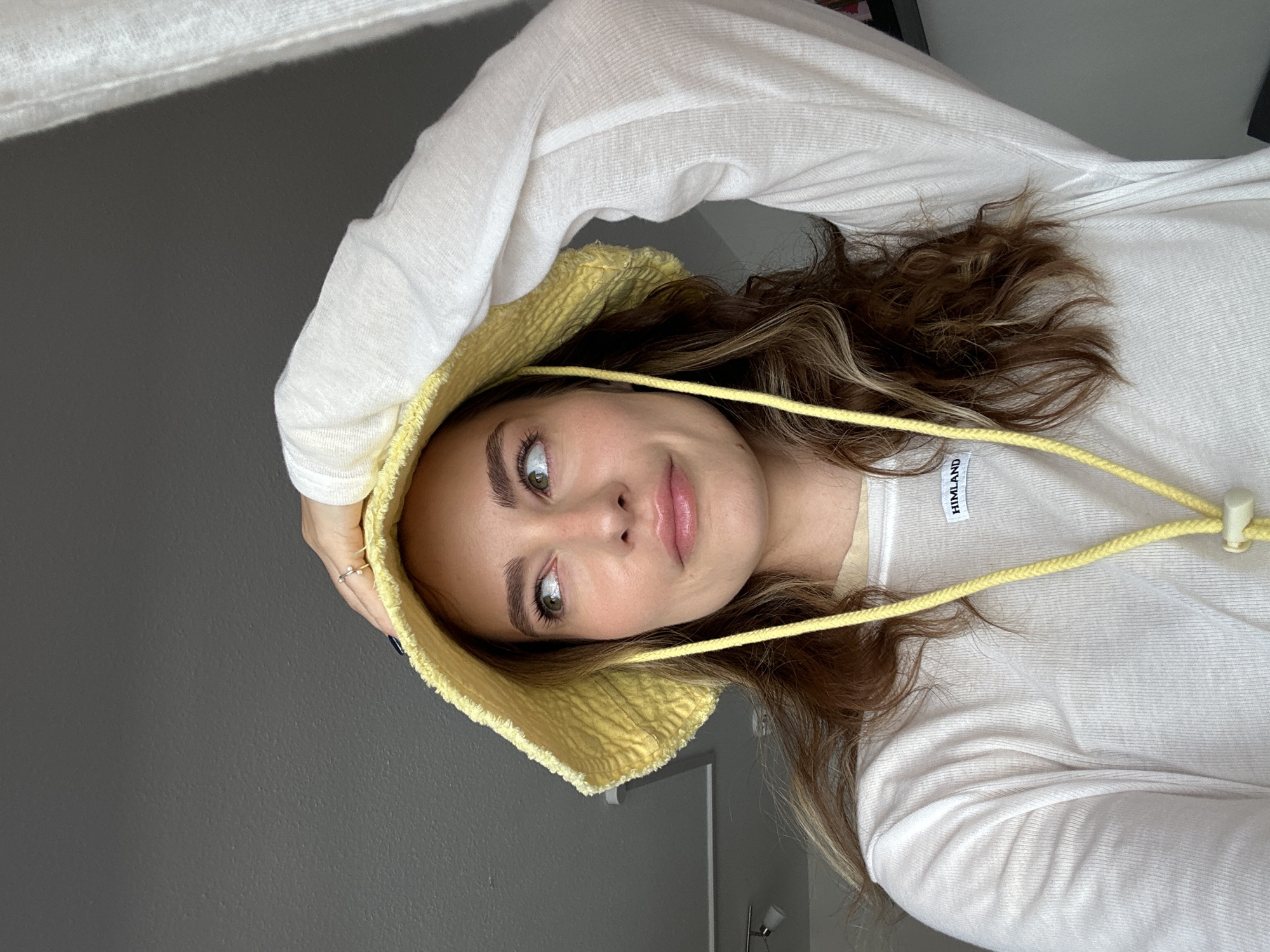 Woman poses for portraits in yellow hat in Kiel