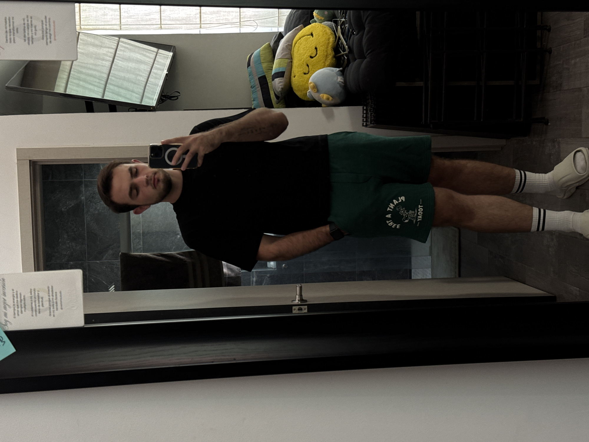 Man takes mirror selfie in Mexican home