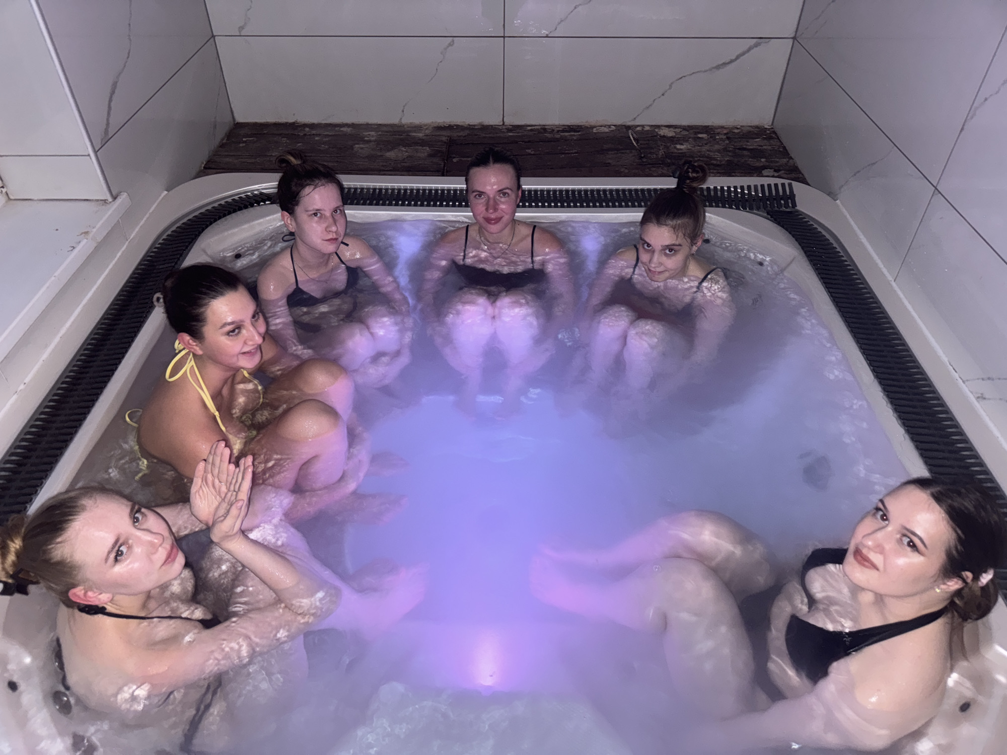 Indoor hot tub session in Perm with color-changing lights