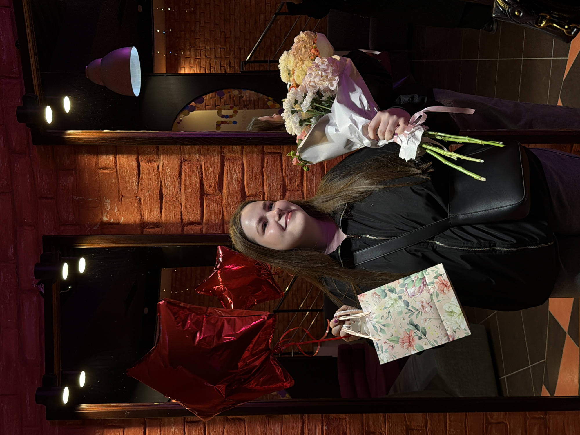Woman celebrates with flowers, bowling in Izhevsk evening outing