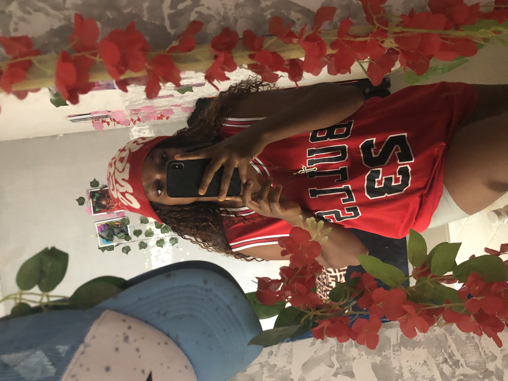 Person takes mirror selfie in red jersey in Kashere