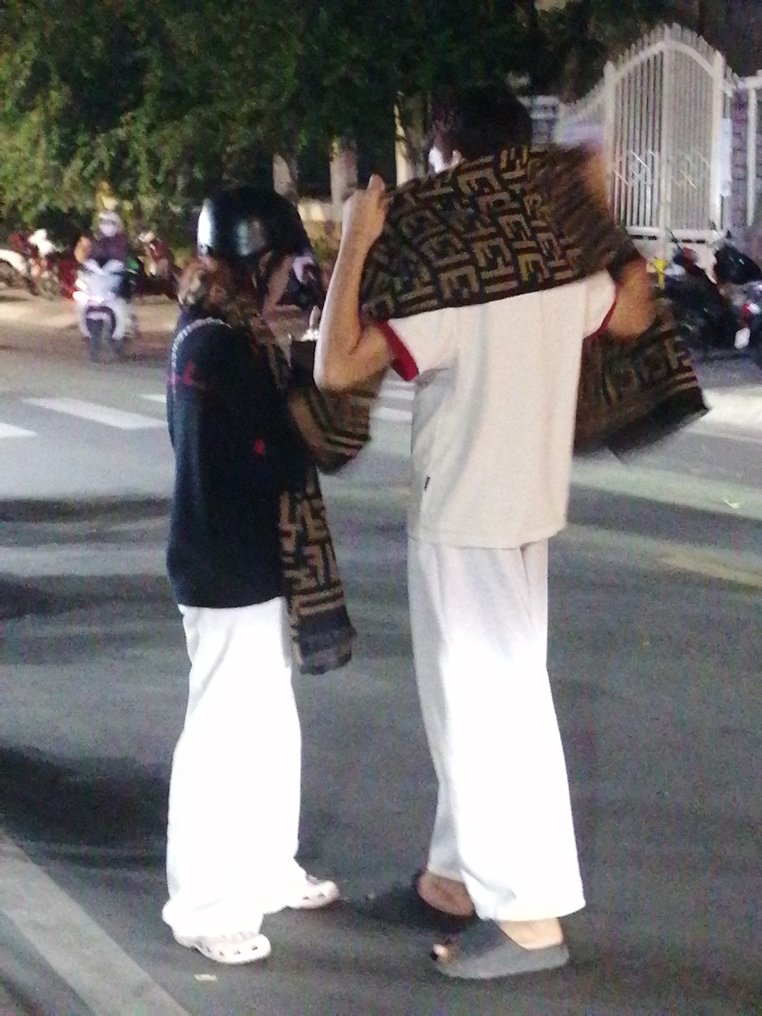 Evening street gathering, small group outside at night