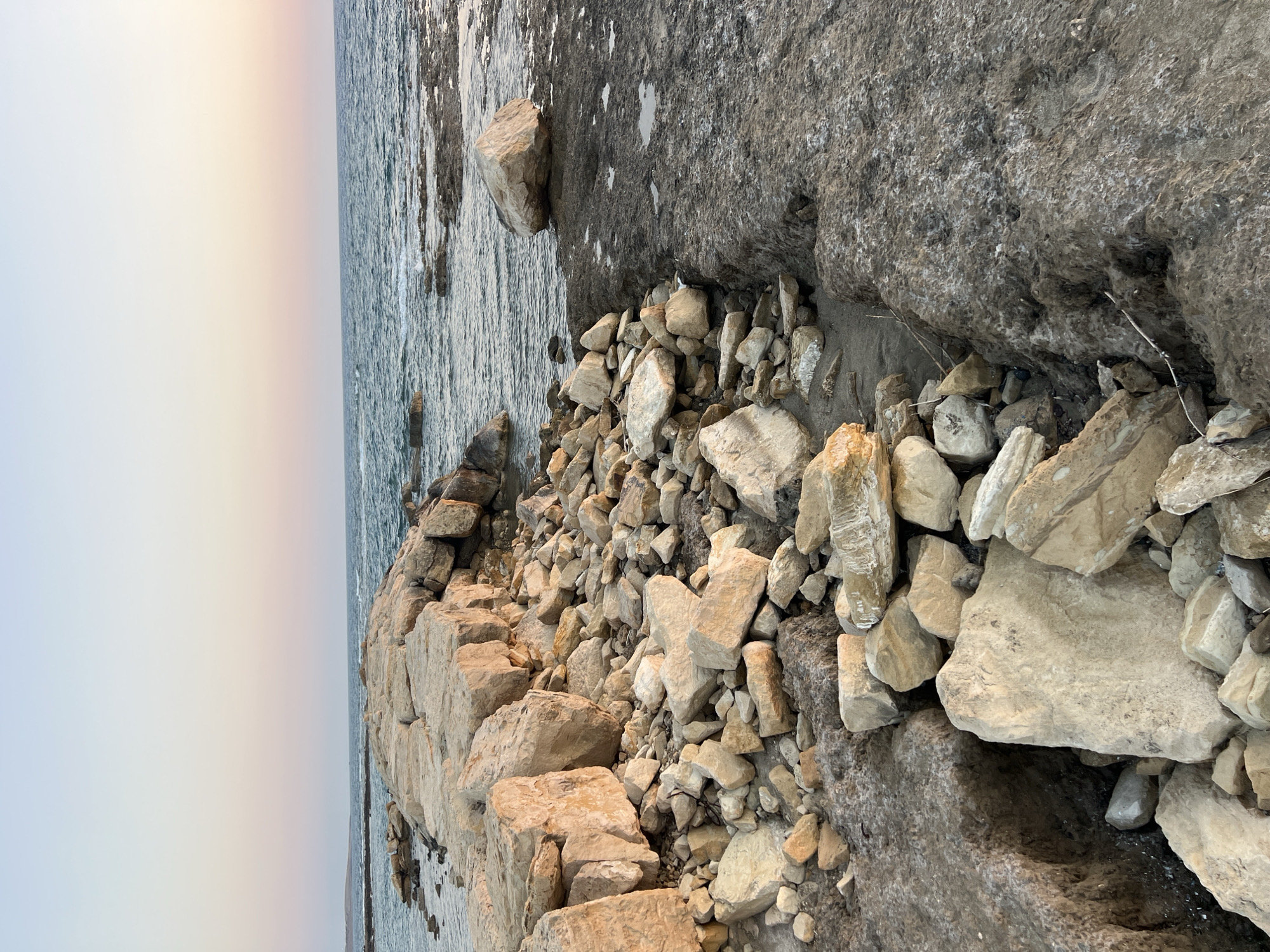 Akrotiri's rocky coast and harbor on a July afternoon