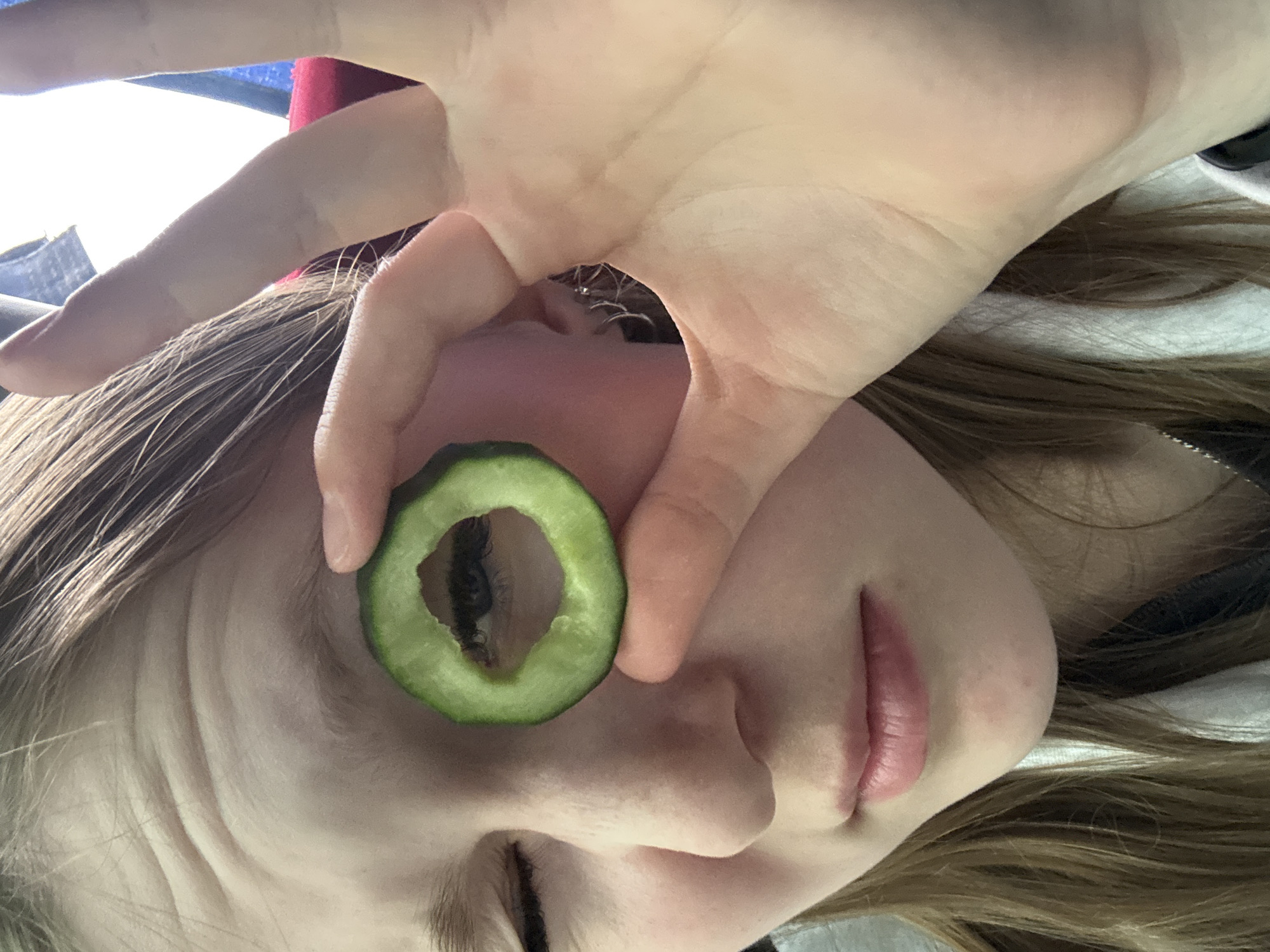 Person uses makeshift cucumber eyepiece in Zvyozdny, Russia