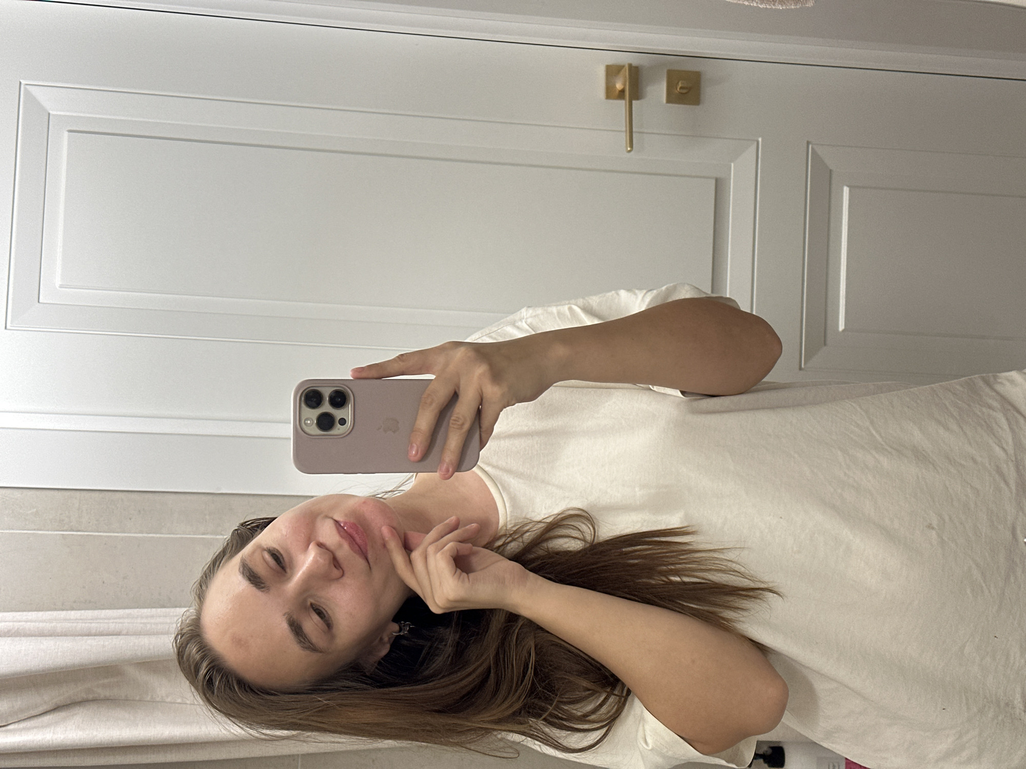 Woman takes selfies with dragon plushie in Kharnavy bathroom