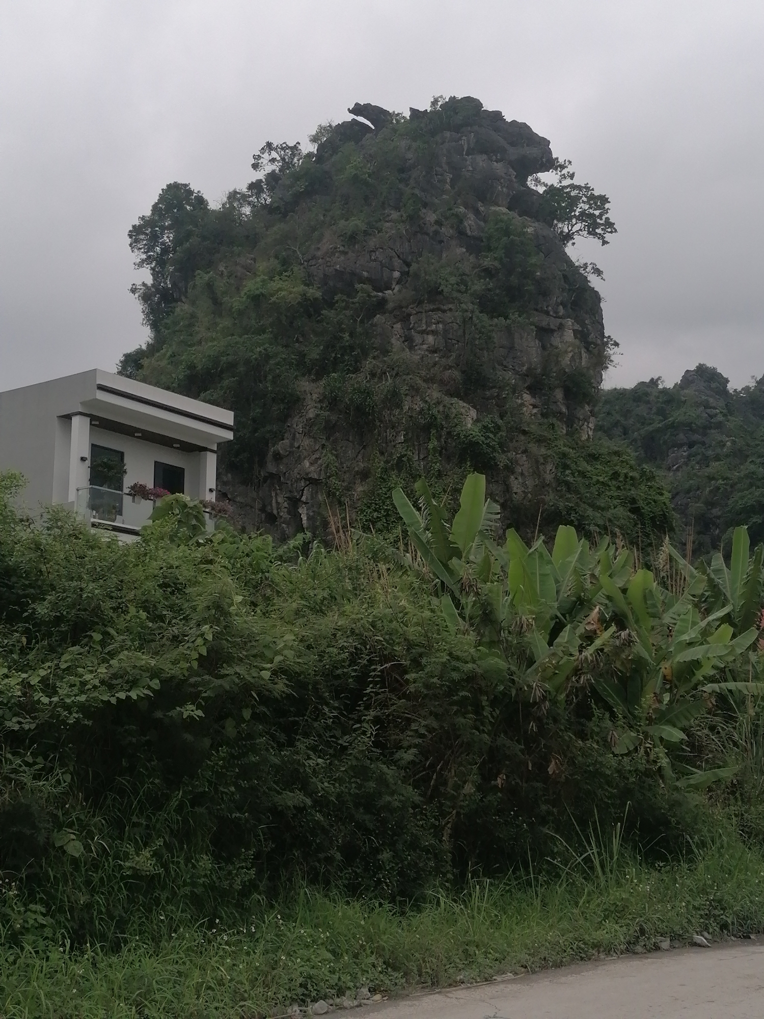 Morning bus depot operations amid limestone mountains, Ha Tu Ward