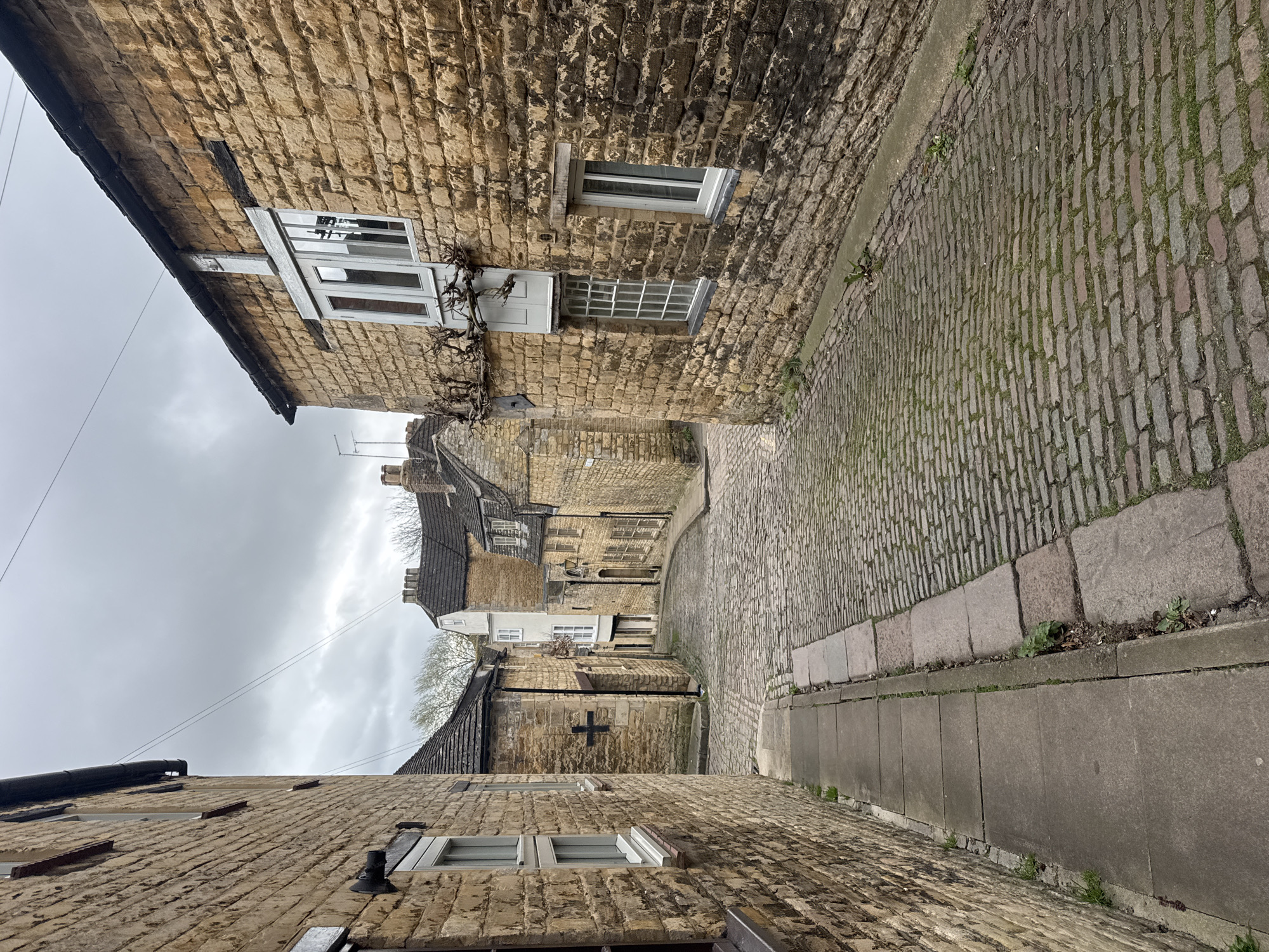 Cobblestone street with stone buildings observed in South Kesteven