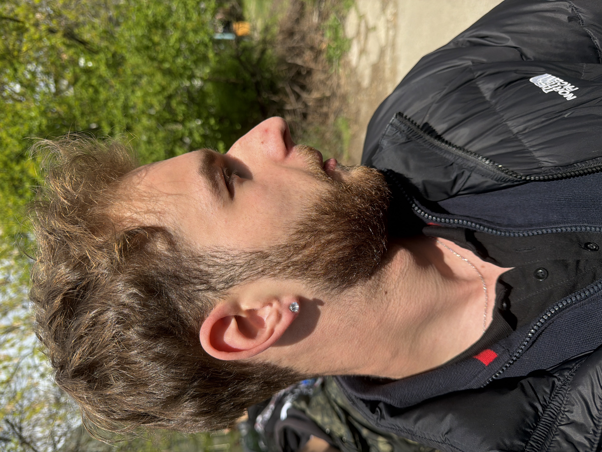 Young man photographed in profile outdoors in Sofia
