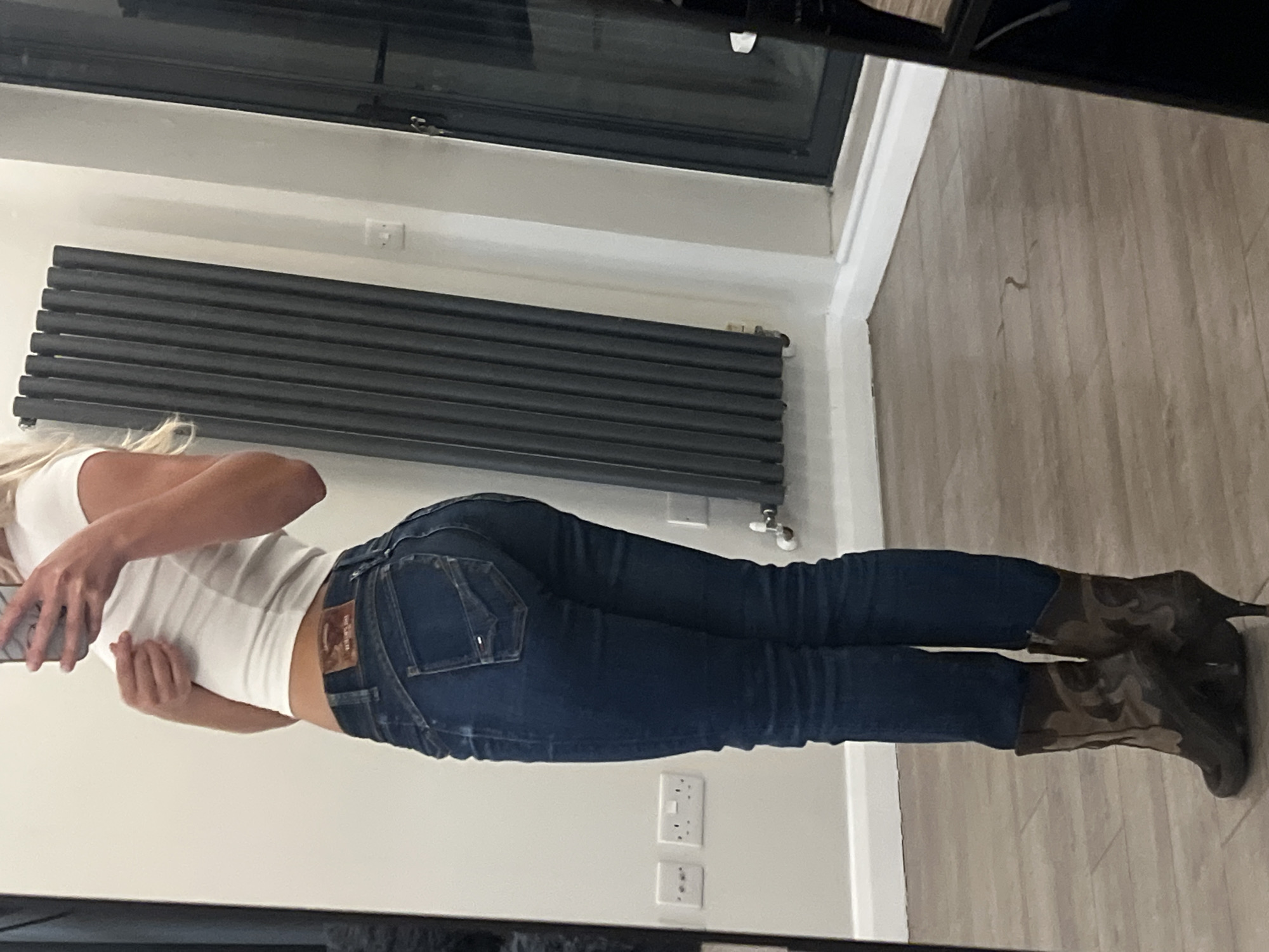Woman in camouflage boots photographed indoors in London residence