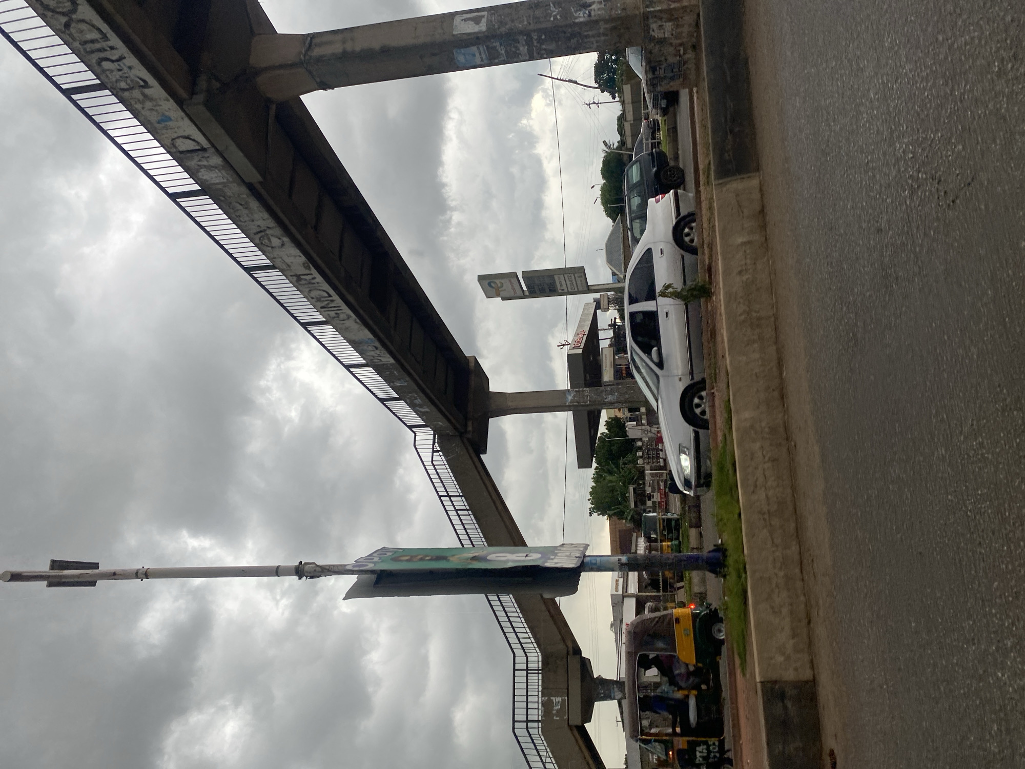 Wet streets and keke napeps in Gura Top on a cloudy afternoon