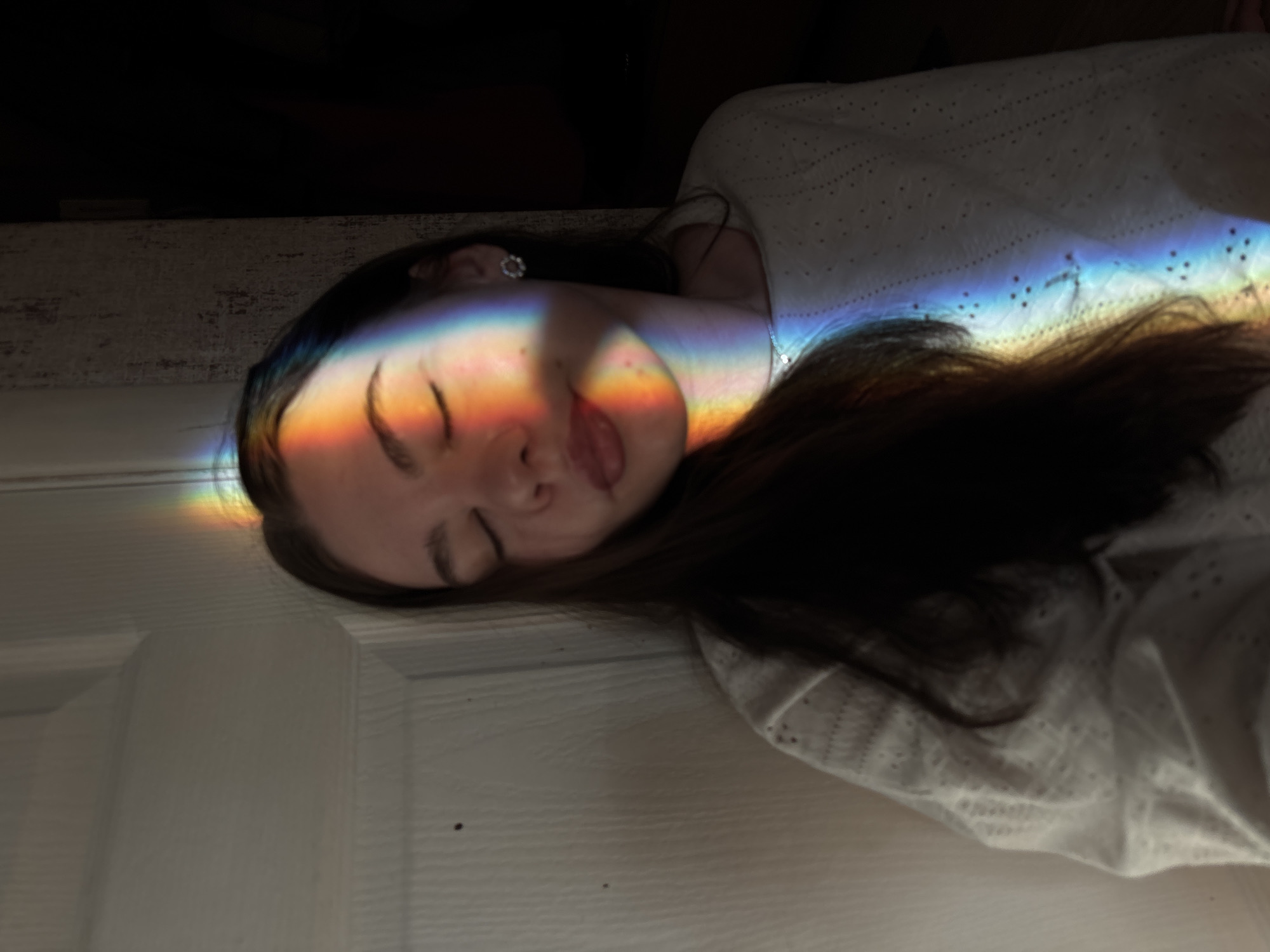 Person resting amid colorful lights documented in Perm, Russia