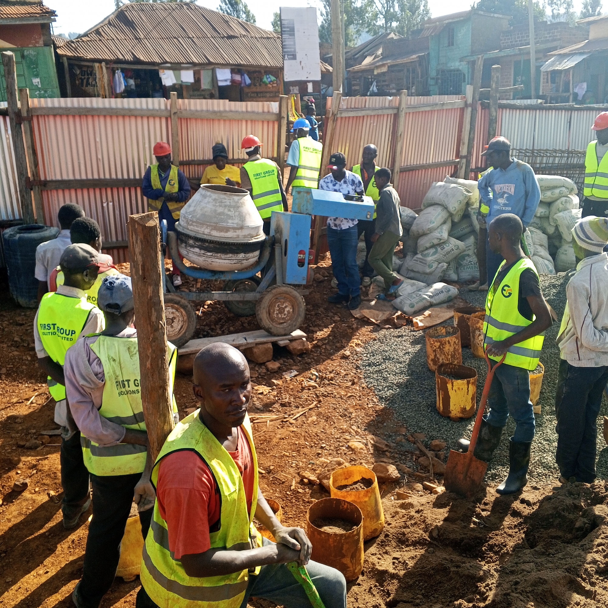 Construction workers mix concrete at Kenya building site