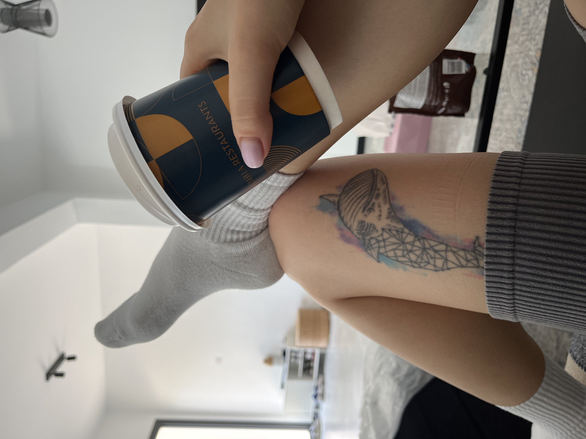 Woman enjoys morning coffee on couch in Limassol