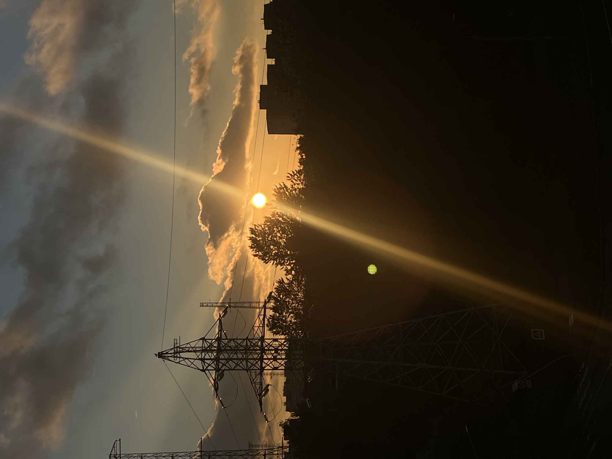 Golden sunset over Saint Petersburg rooftops and power pylons
