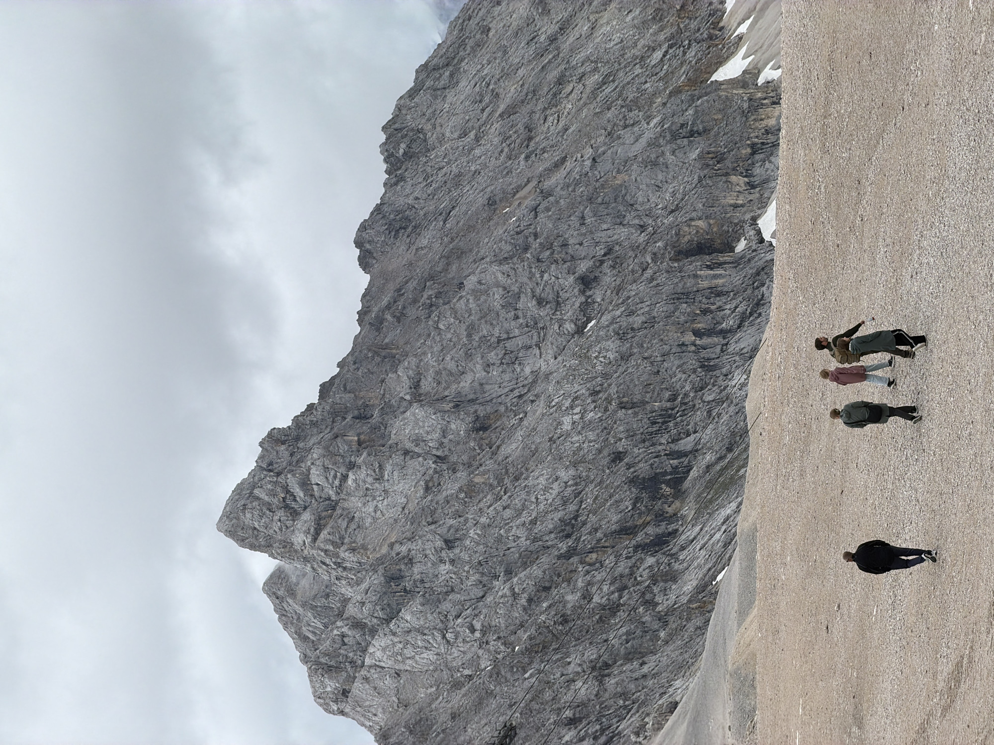 Hikers and a mountain chapel on rocky terrain near Garmisch-Partenkirchen