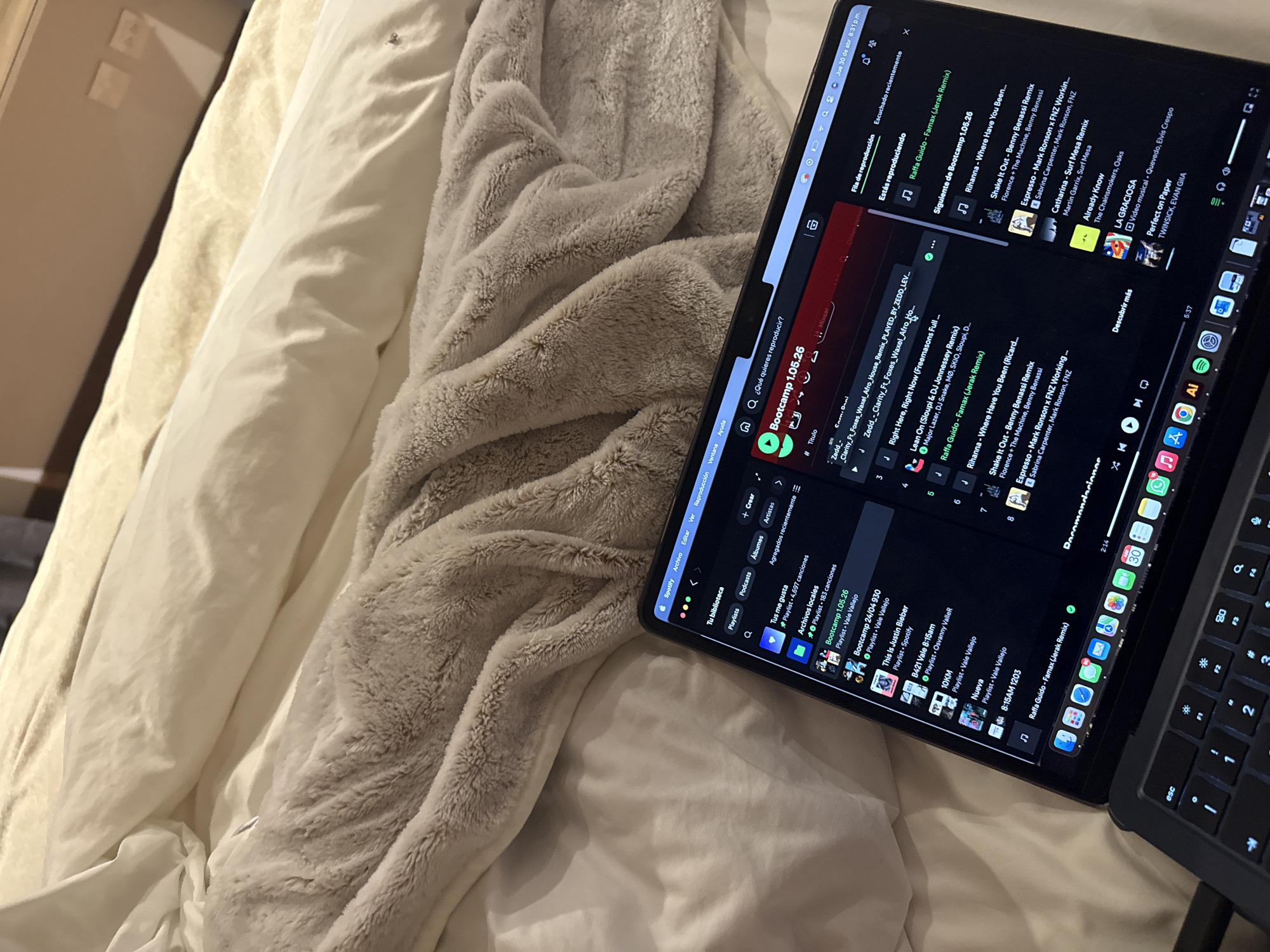 MacBook with Spotify captured on bed in Mexican bedroom