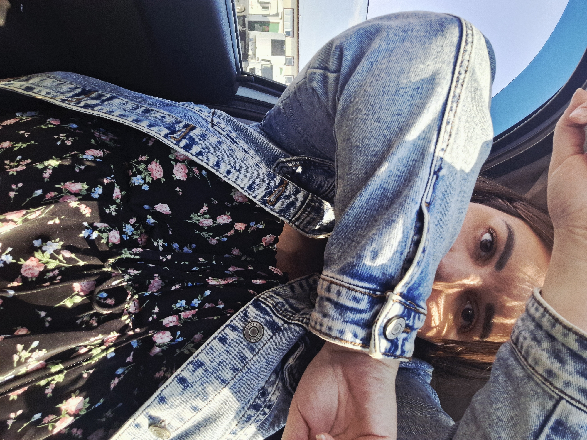 Woman in floral dress documented near vehicle in Izhevsk