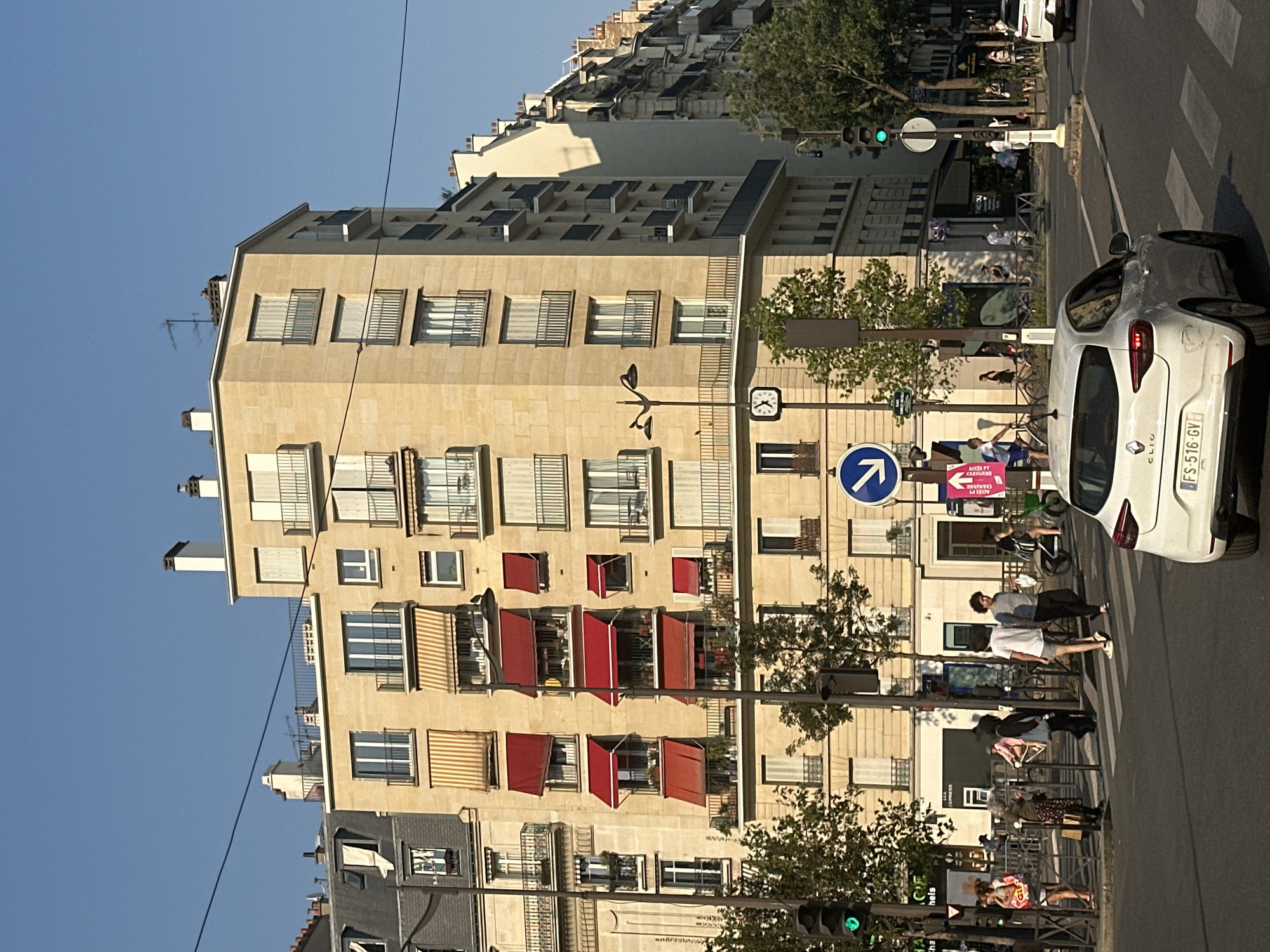 Quiet afternoon around a Parisian neighborhood carousel and café strip
