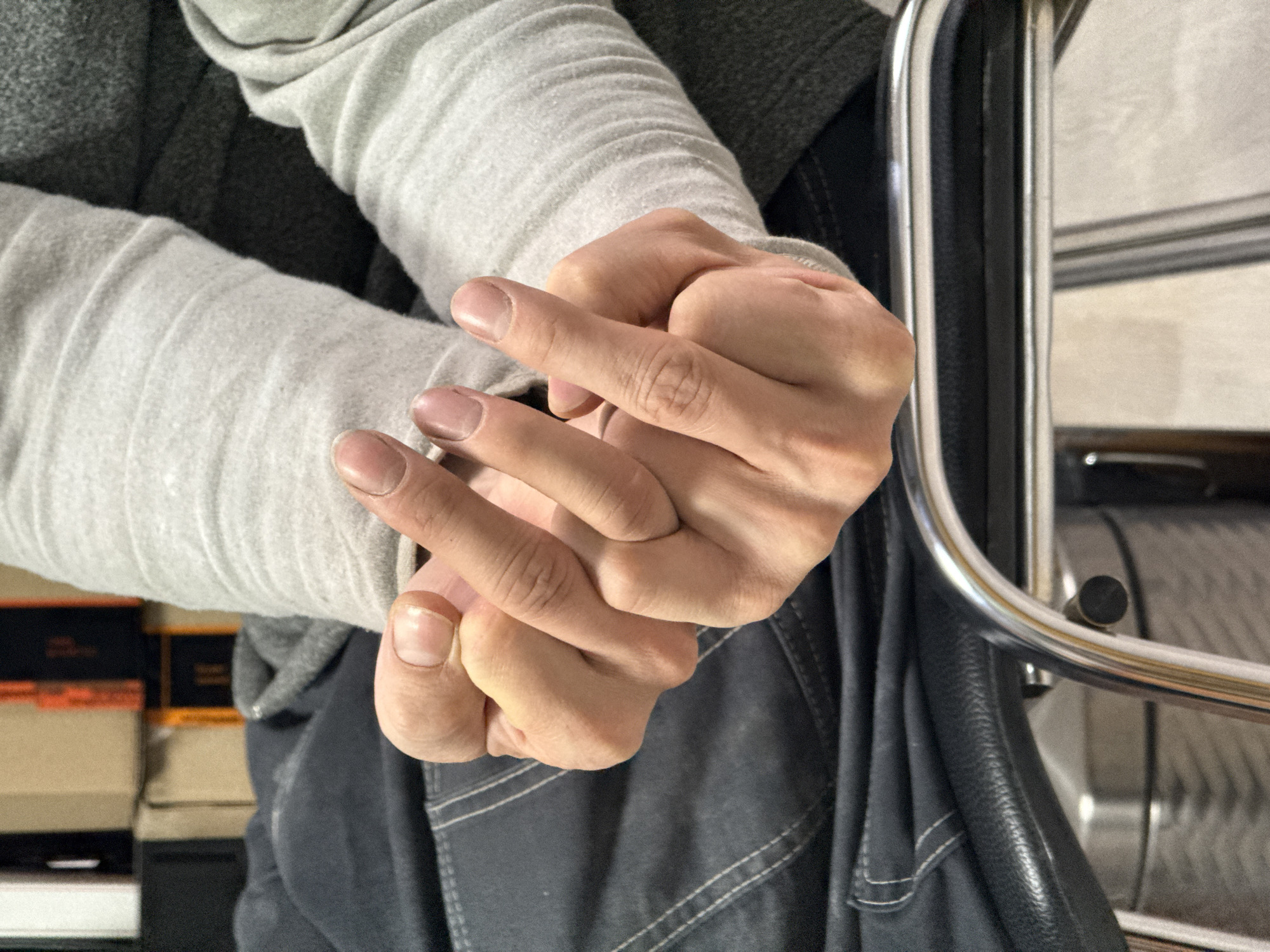 Clasped hands photographed indoors in Chaikovsky, Russia