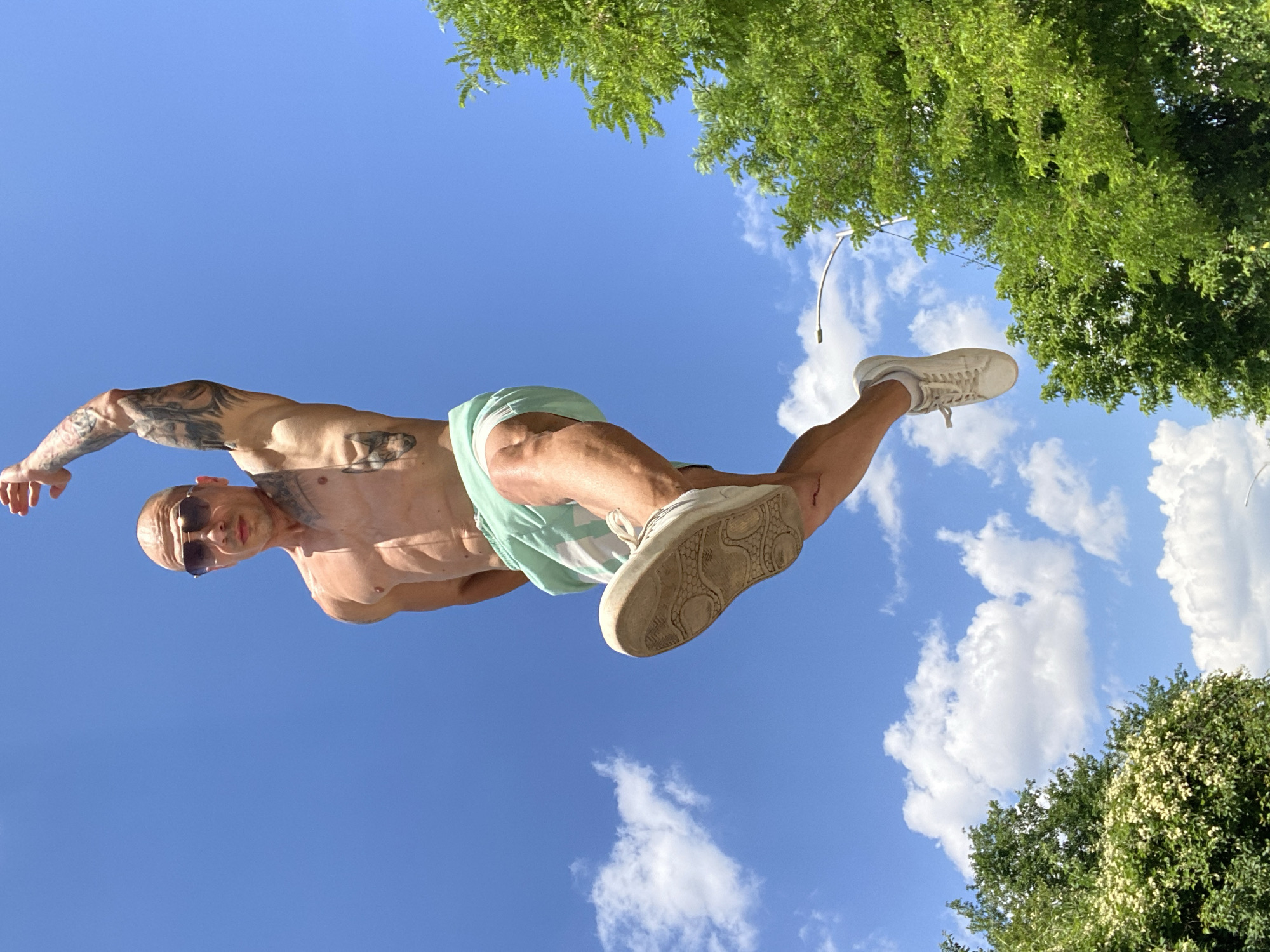 Tattooed, shirtless and jumping on a sunny Pleven street