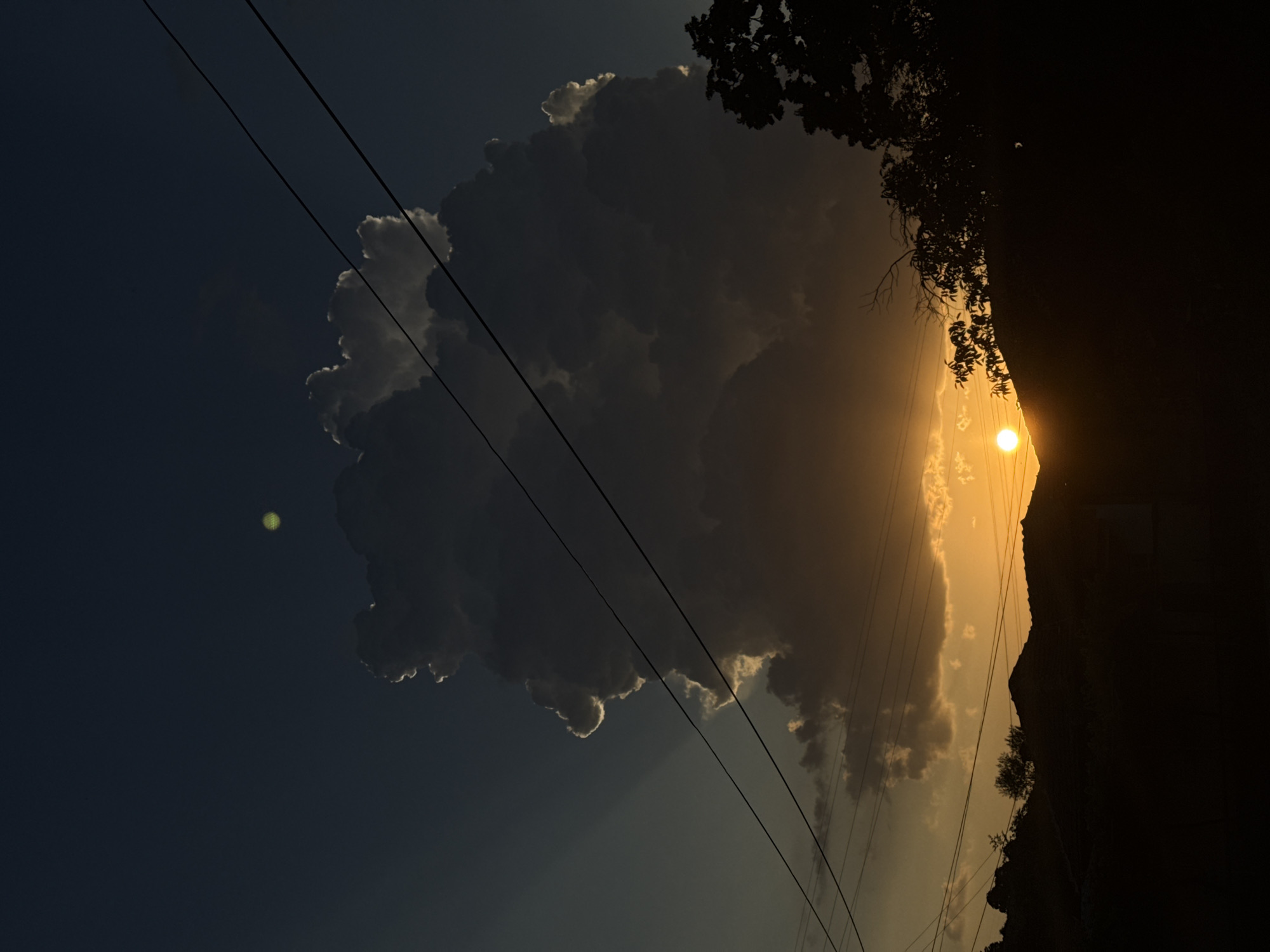Storm cloud backlit by setting sun over central Bulgaria