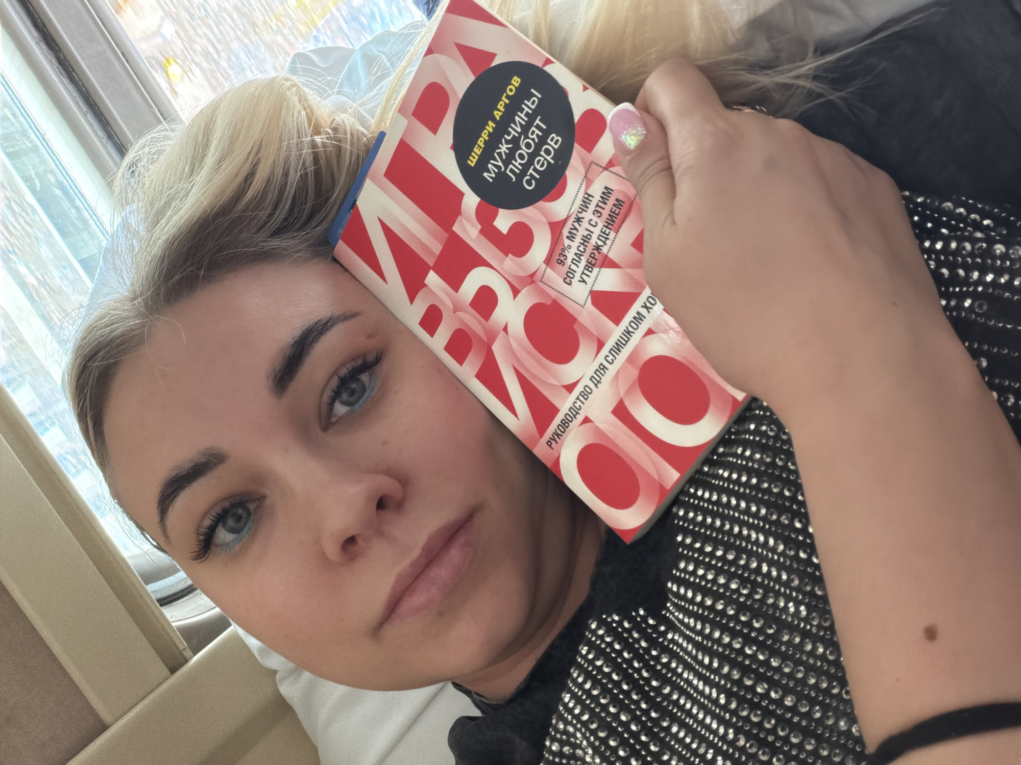 Woman reads book on train in Varlamovo, Russia