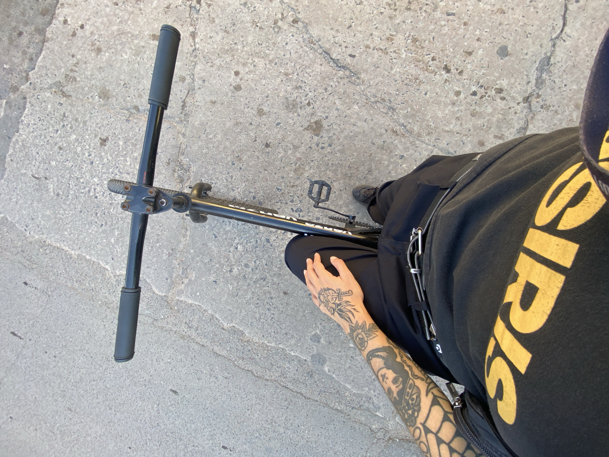 Person with tattooed arm photographed with bicycle in Argentina