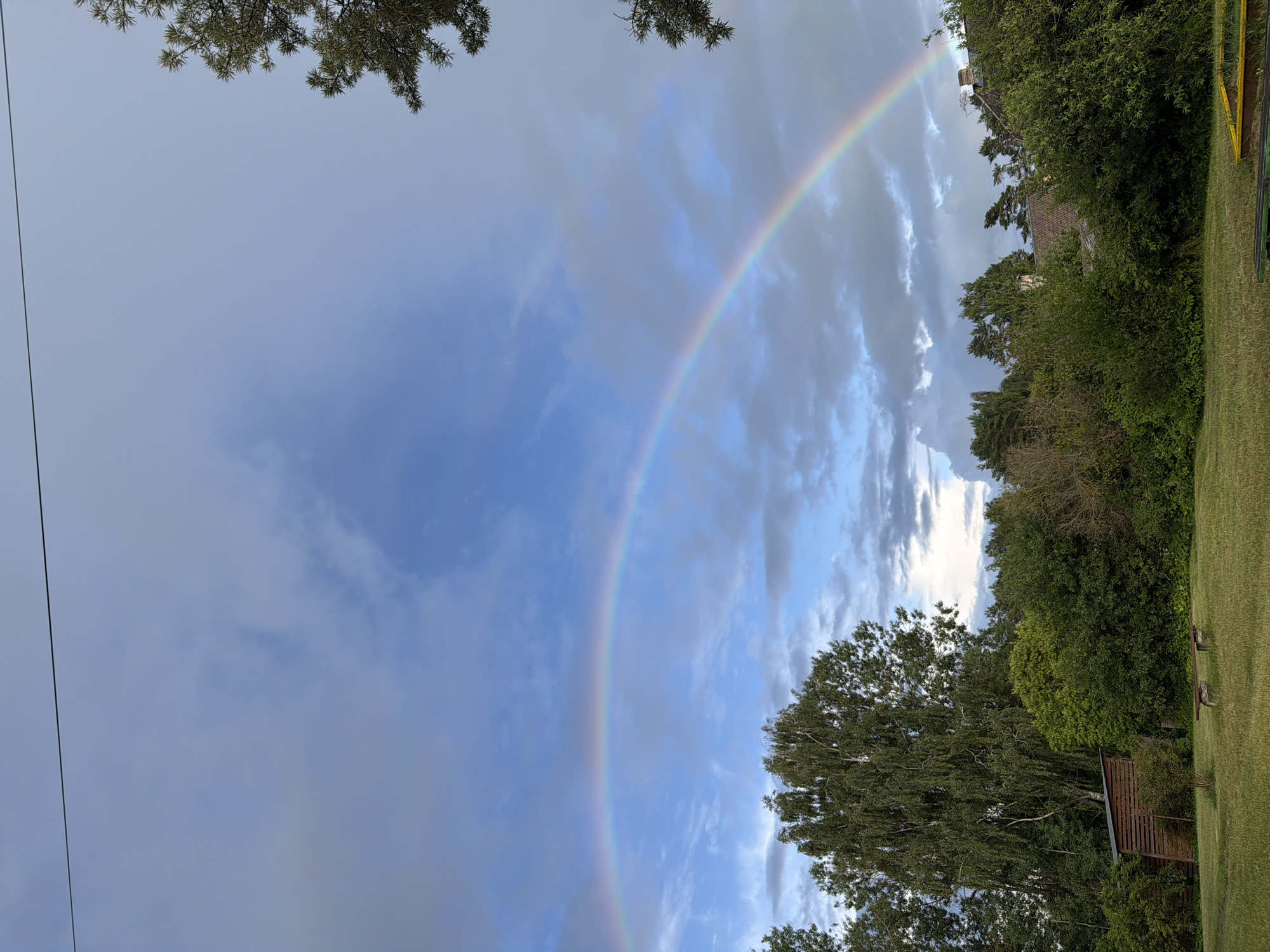 Rainbow over a quiet field in rural Latvia