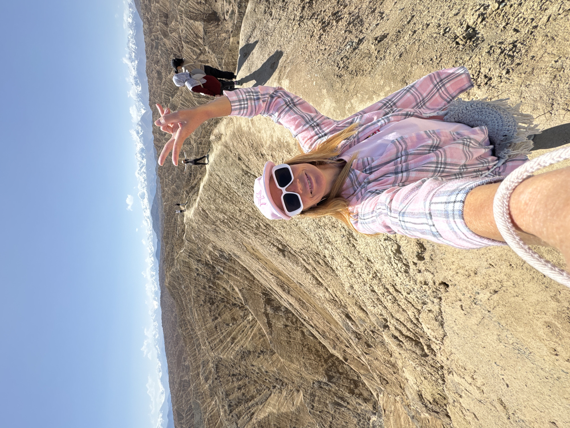Woman poses for selfie on Kyrgyzstan ridge