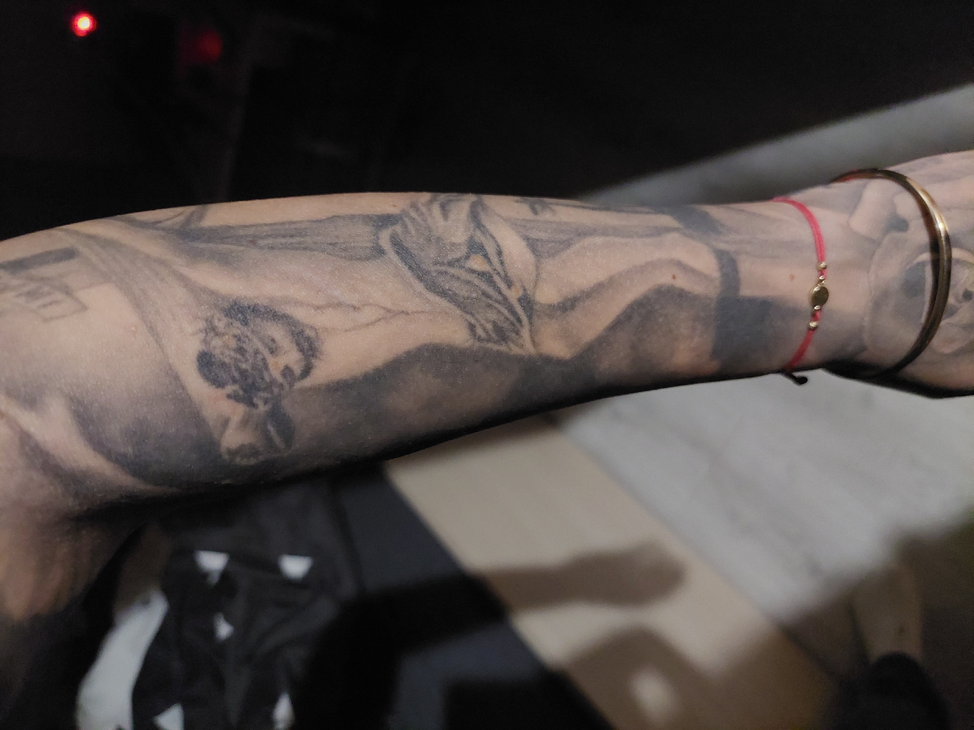 Tattooed individual photographed in Plovdiv showing religious and floral ink