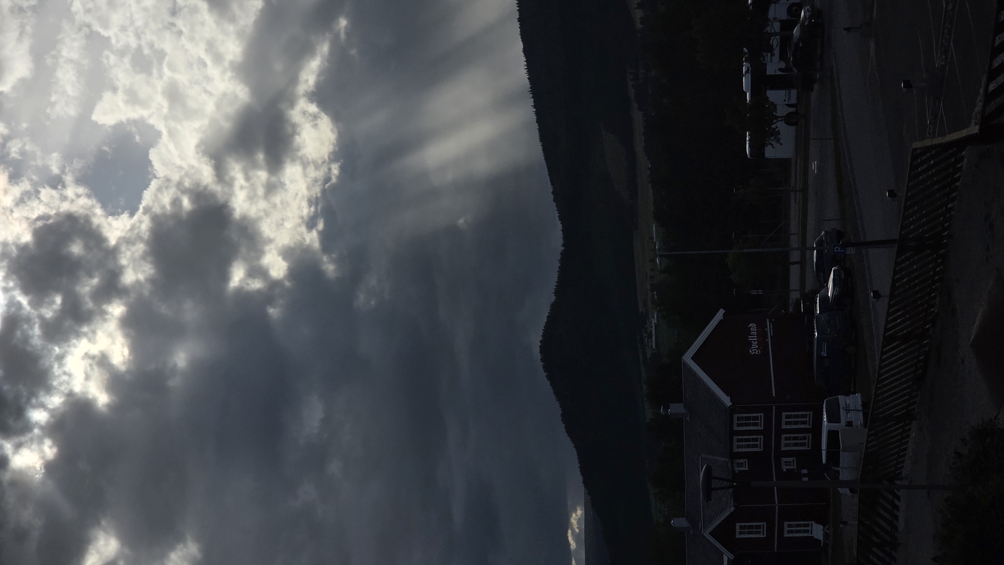 Dramatic light breaks over Tynset's rural landscape and church