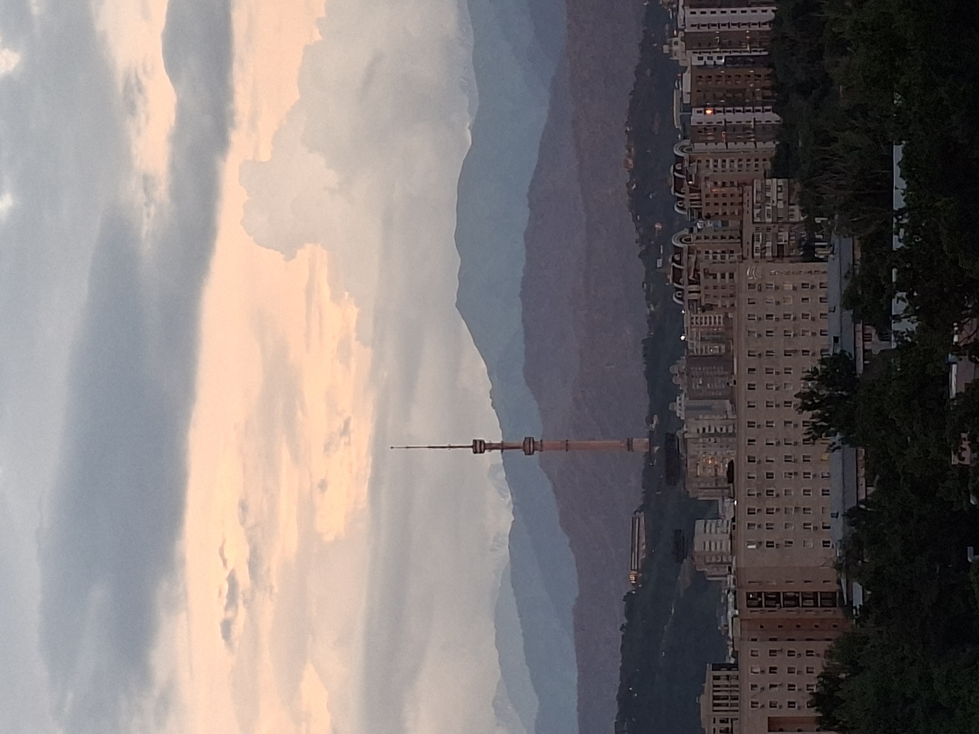 Almaty at dusk: skyline, TV tower, and mountain views