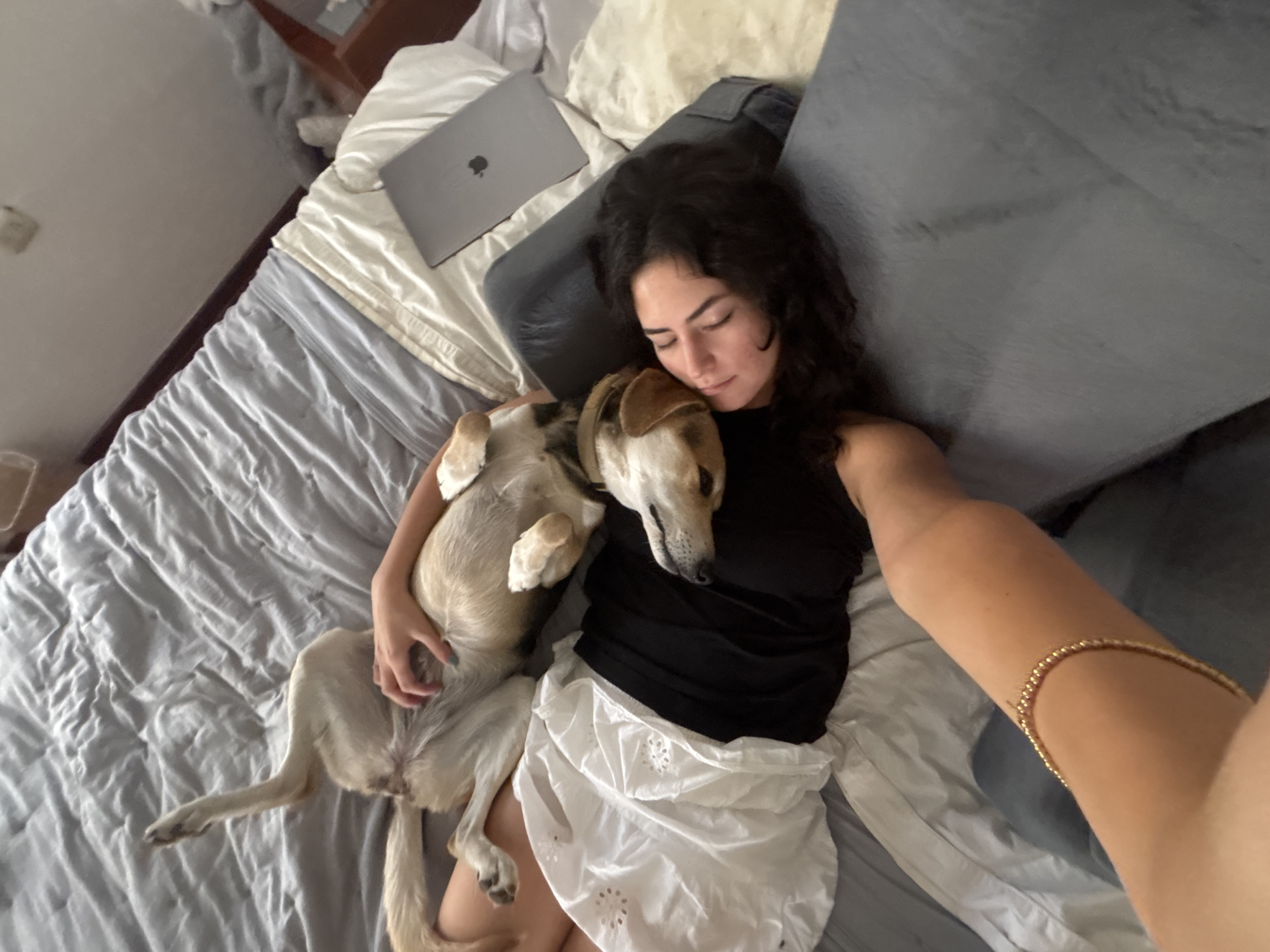 Woman rests with dog in Puebla home