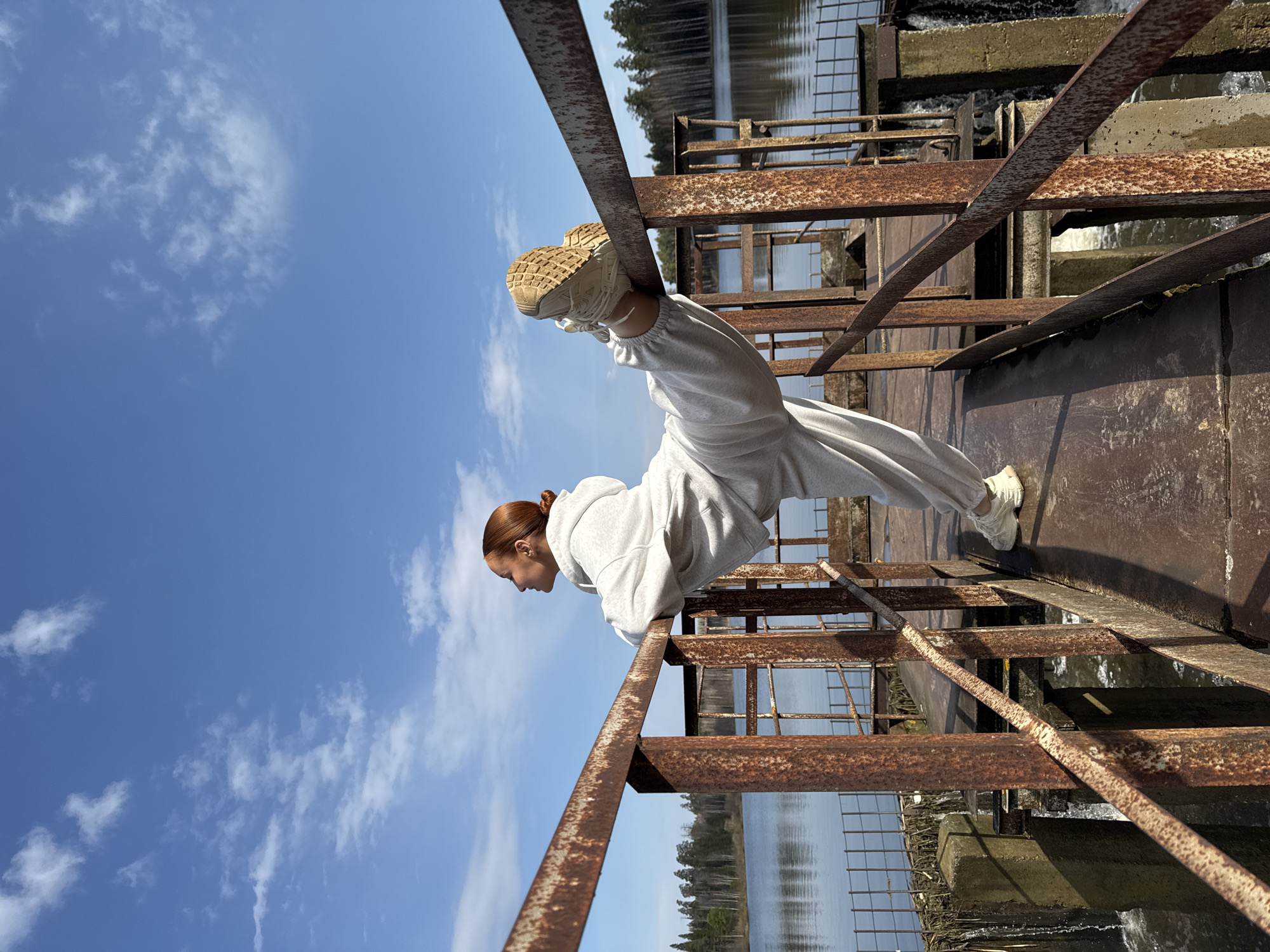 Woman performs balancing act on metal structure in Opary