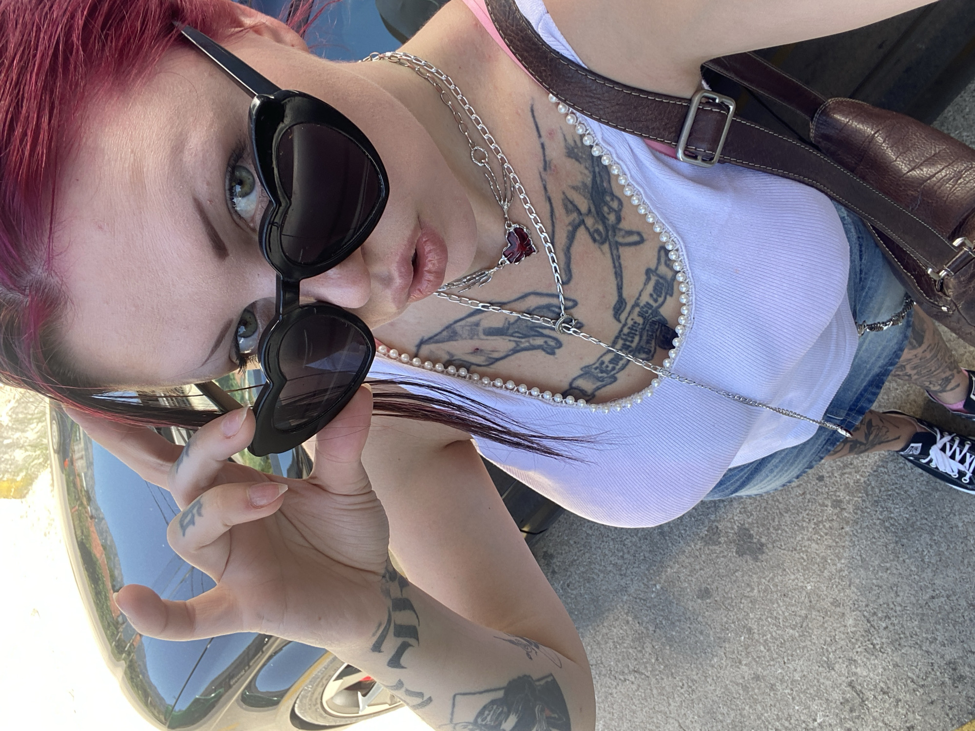 Woman takes selfies in heart sunglasses in Montenegro village