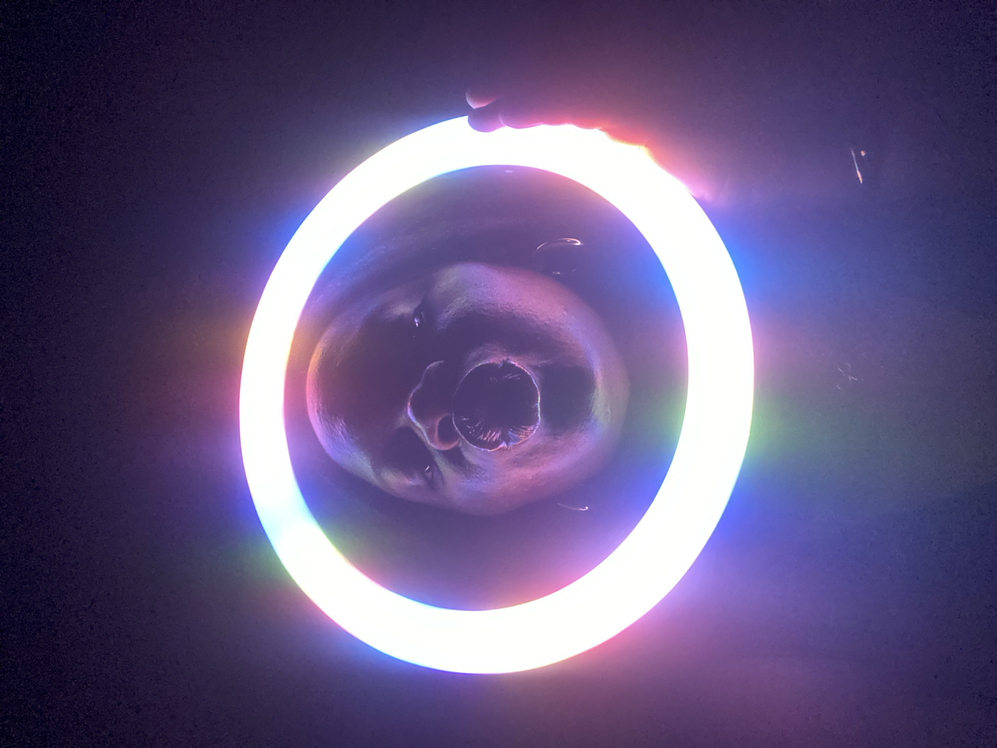 Person experiments with LED ring light and lasers in Nigeria