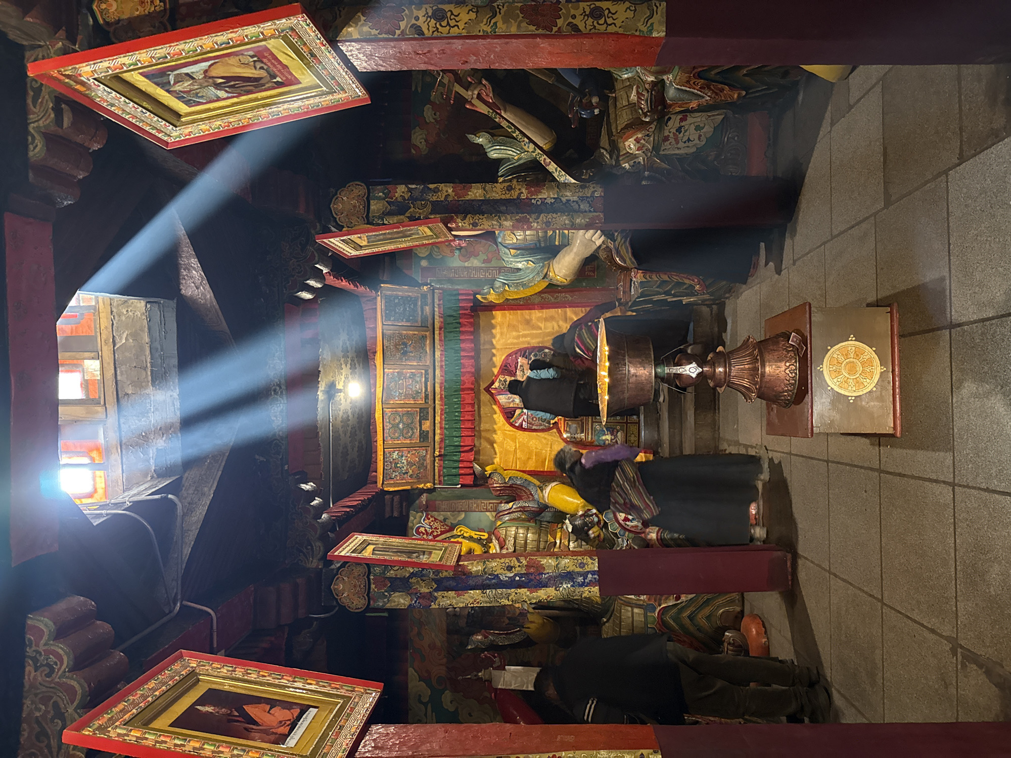 Buddhist temple interior documented with ornate decorations and sunlight