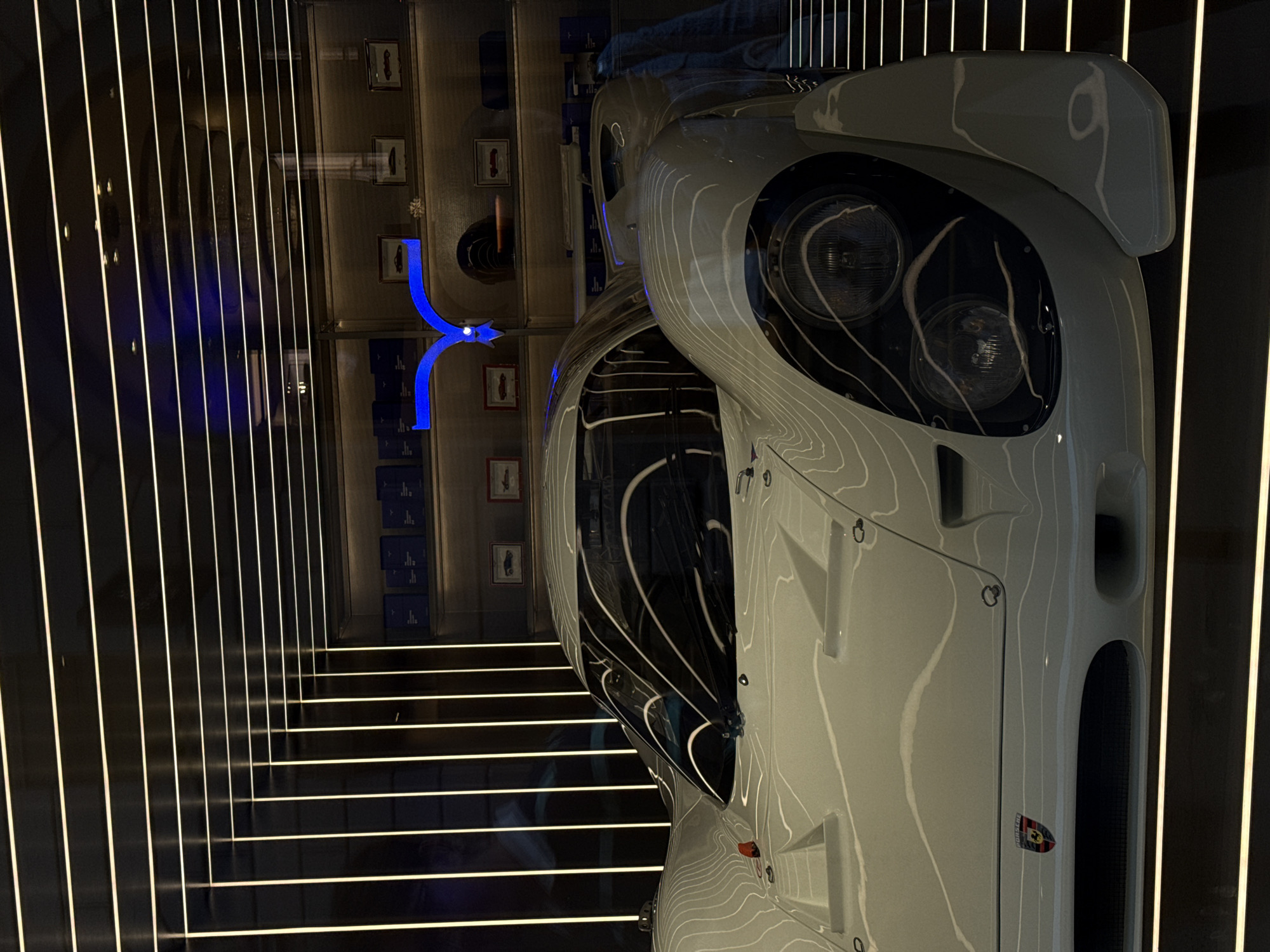 White sports car displayed in Milan showroom exhibit