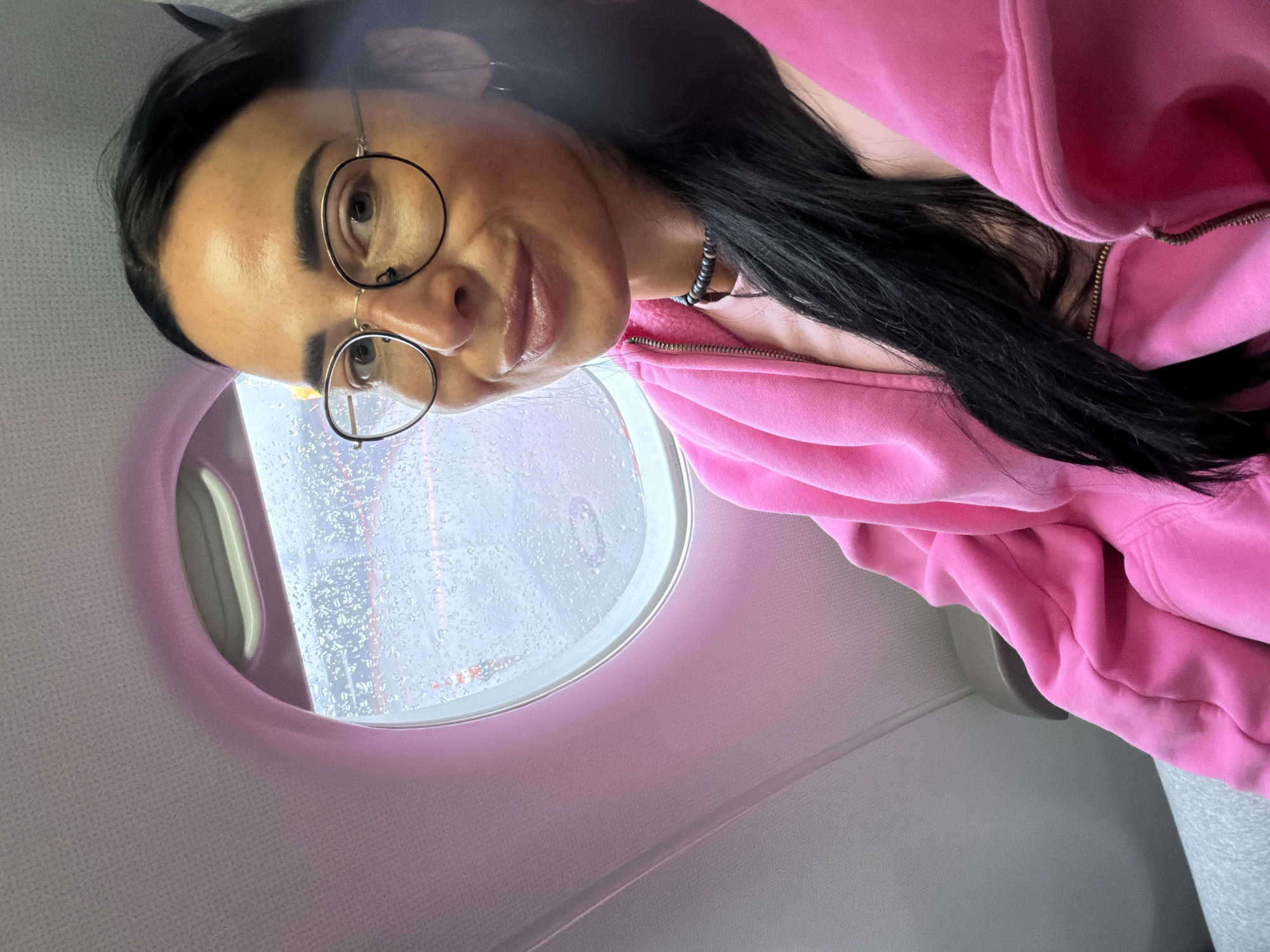 Woman takes airplane selfies during rainy flight in Khimki