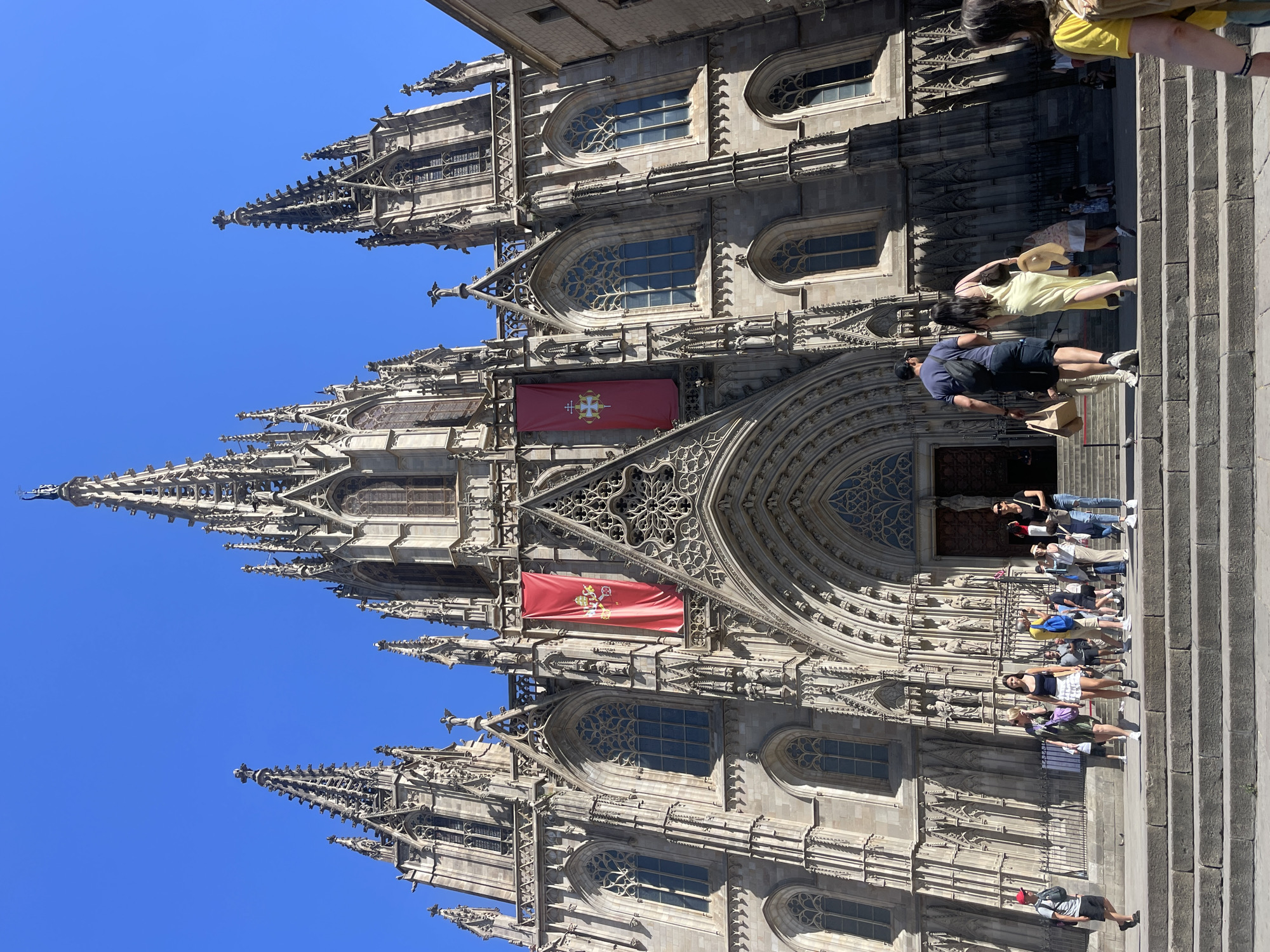 Tourists photograph Barcelona Cathedral and mosaic murals Friday afternoon