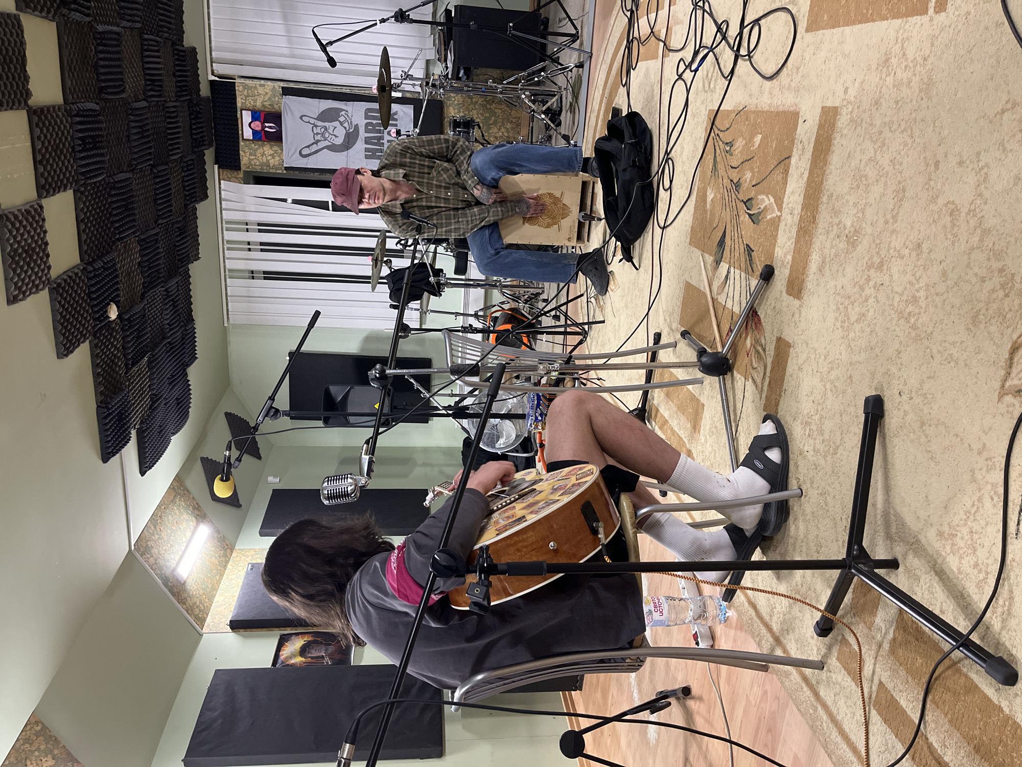 Musicians prepare for recording session in soundproofed studio