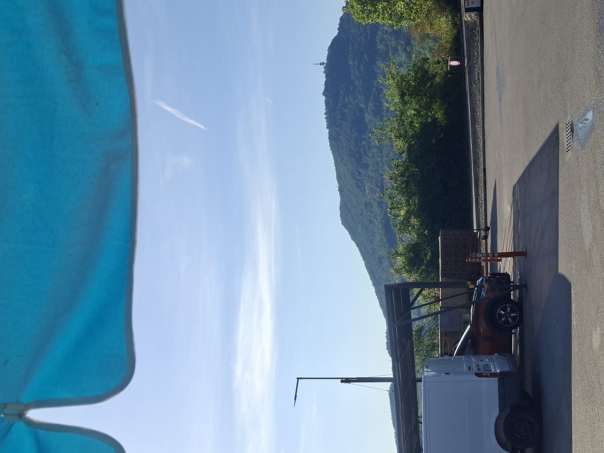 Mountain landscape with blue umbrella observed under clear skies