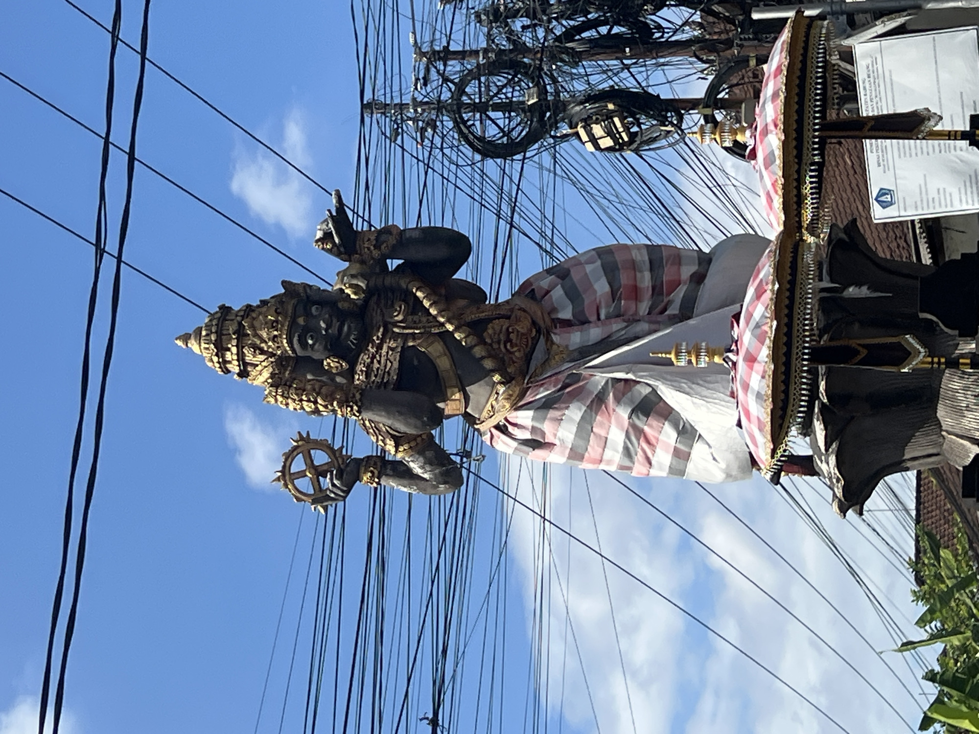 Multi-faced Hindu statue anchors a busy North Kuta intersection