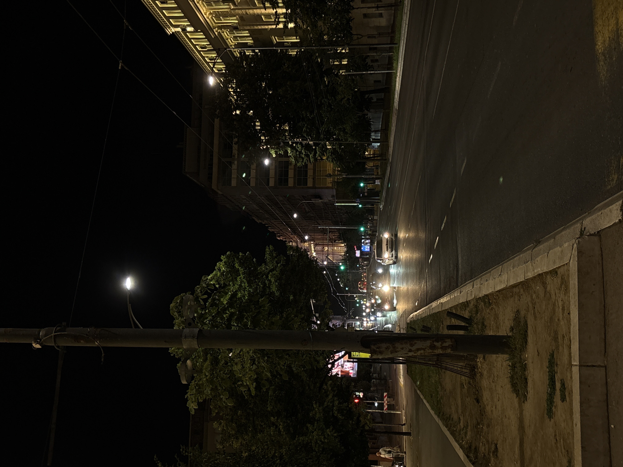 Belgrade streets at night, buses running and people waiting