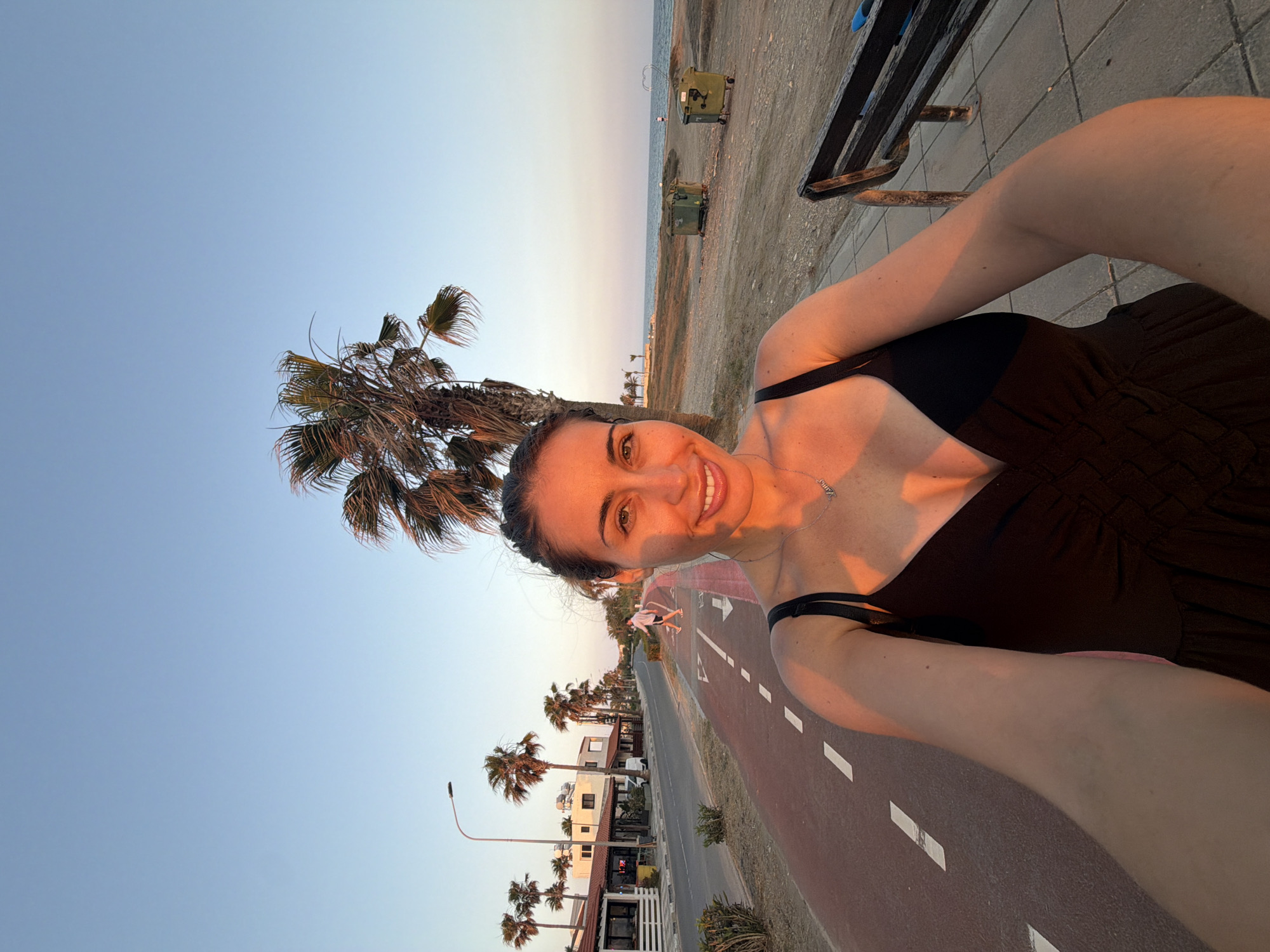 Sunset stroll along Meneou's coastal palm-lined path