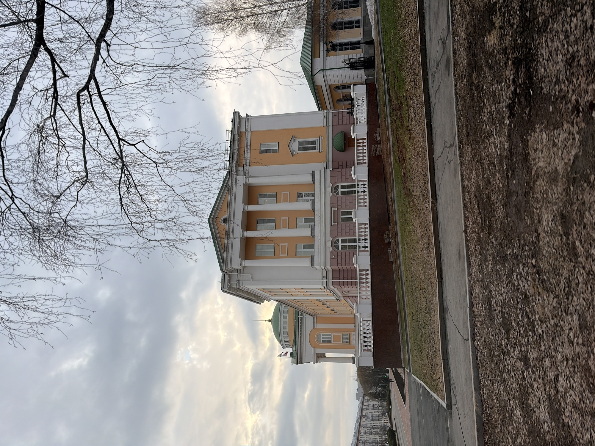 Pedestrian walks past classical building in Izhevsk, Russia