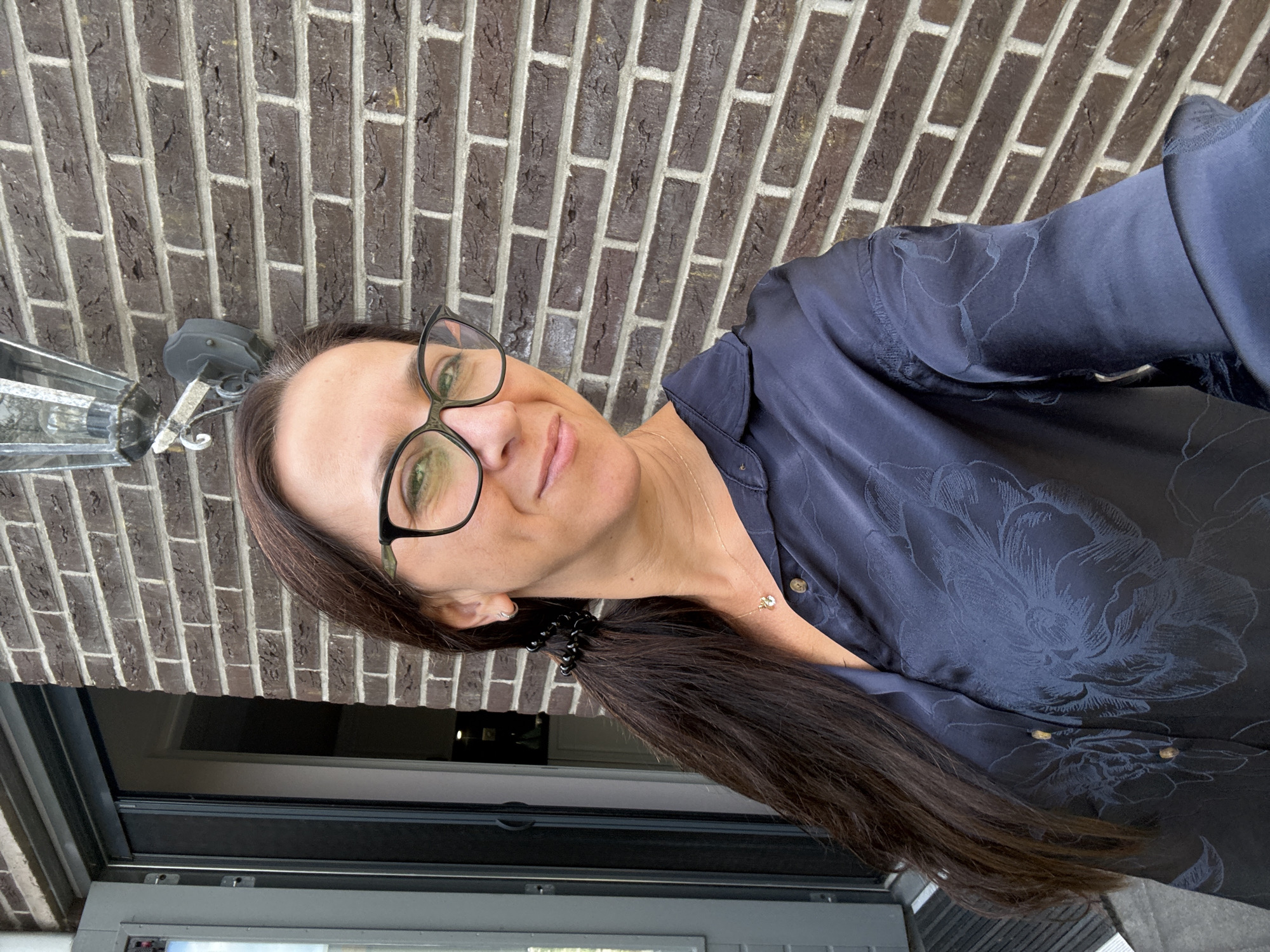 Sunny afternoon selfies outside a brick building in Marum