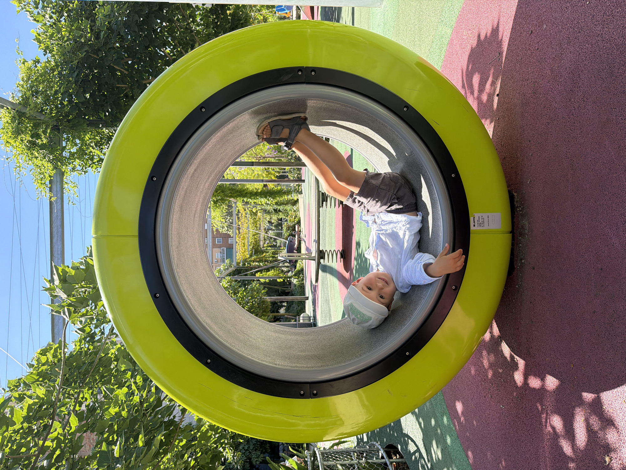 Child plays at modern Barcelona playground Saturday morning