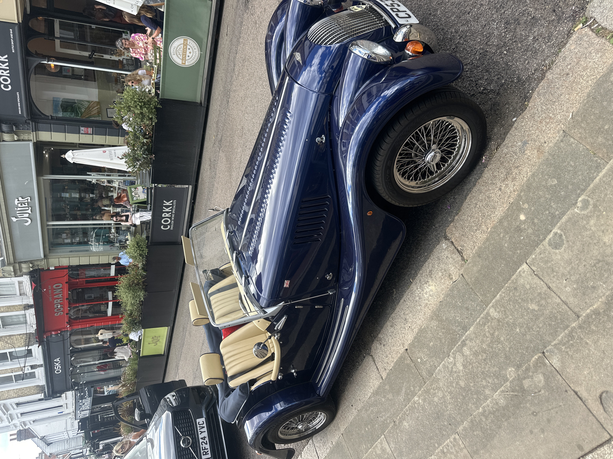 Dark blue convertible parked on a Tunbridge Wells street.