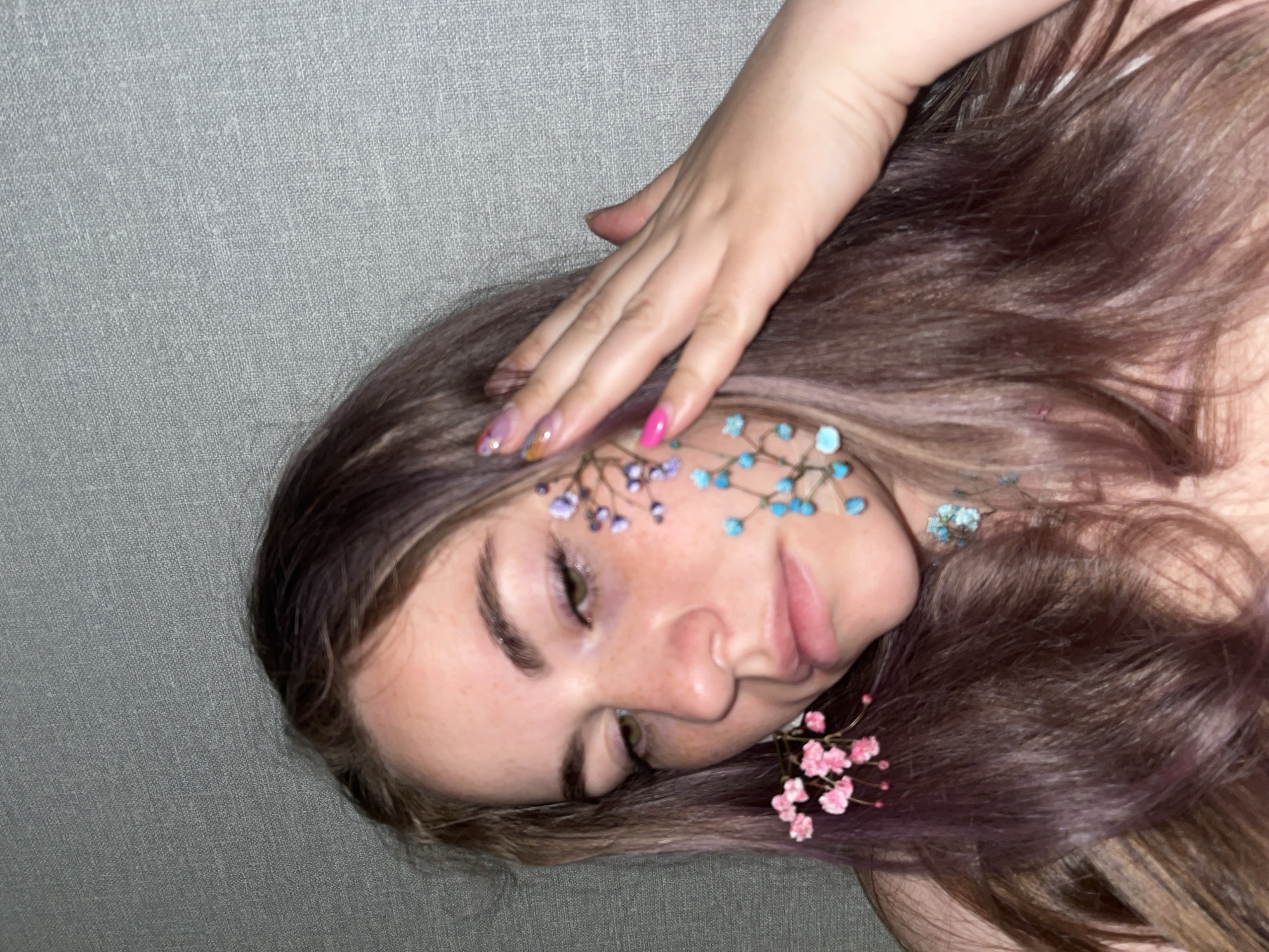 Woman poses with flowers in artistic photo session in Chaikovsky